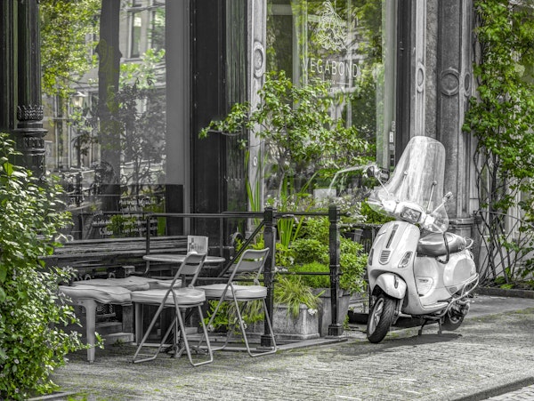 Scooter parked by street cafe