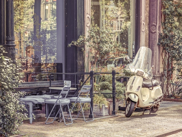 Scooter parked by street cafe 4