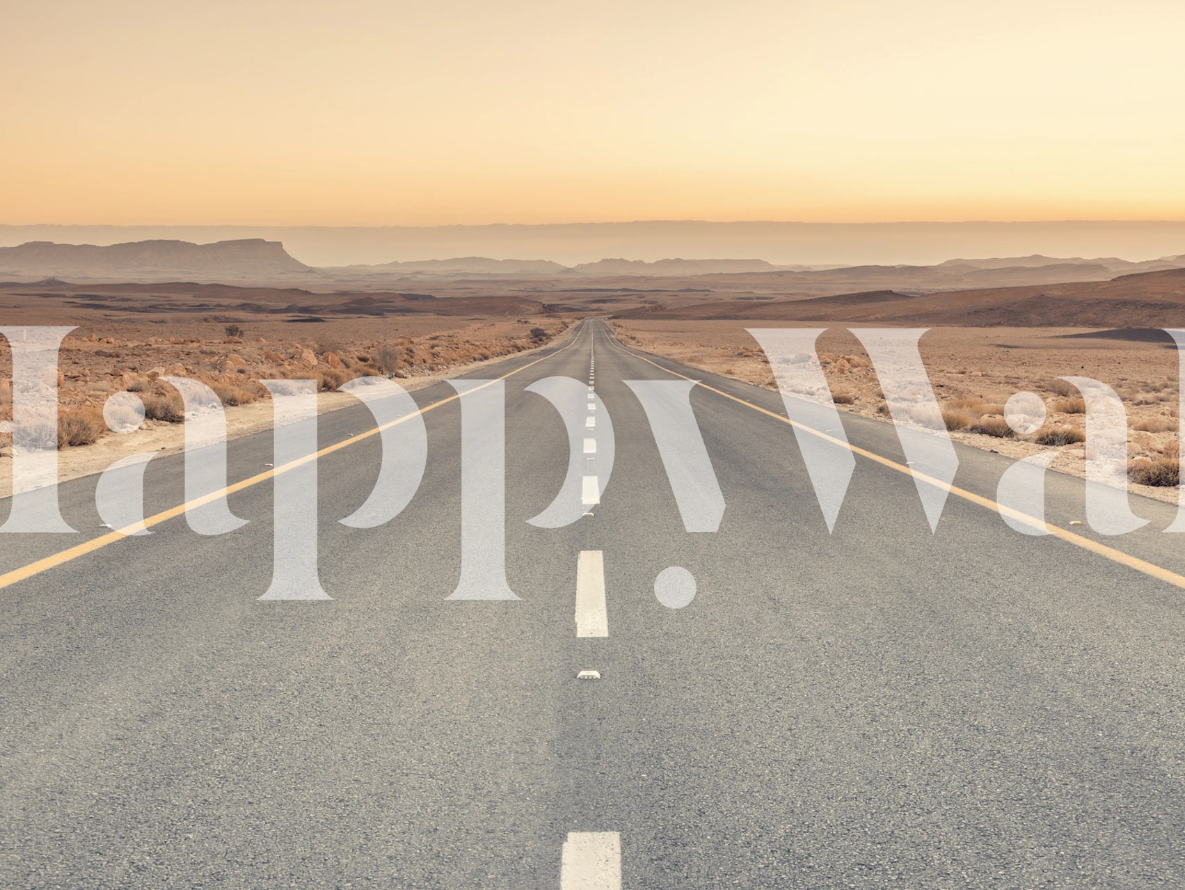 A long desert road with muted tones and vast landscape wallpaper