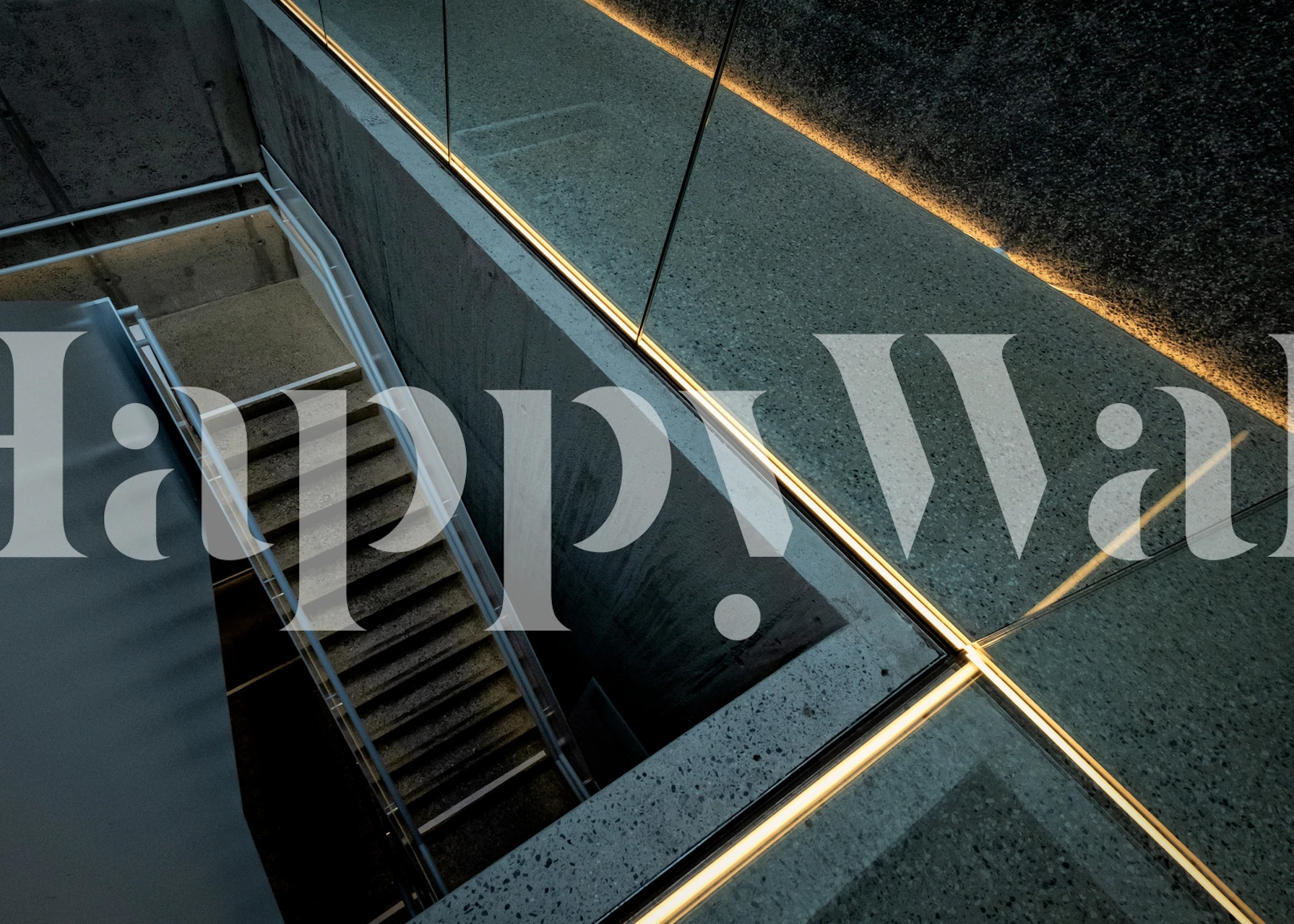 Concrete staircase with warm lighting and modern glass elements wallpaper