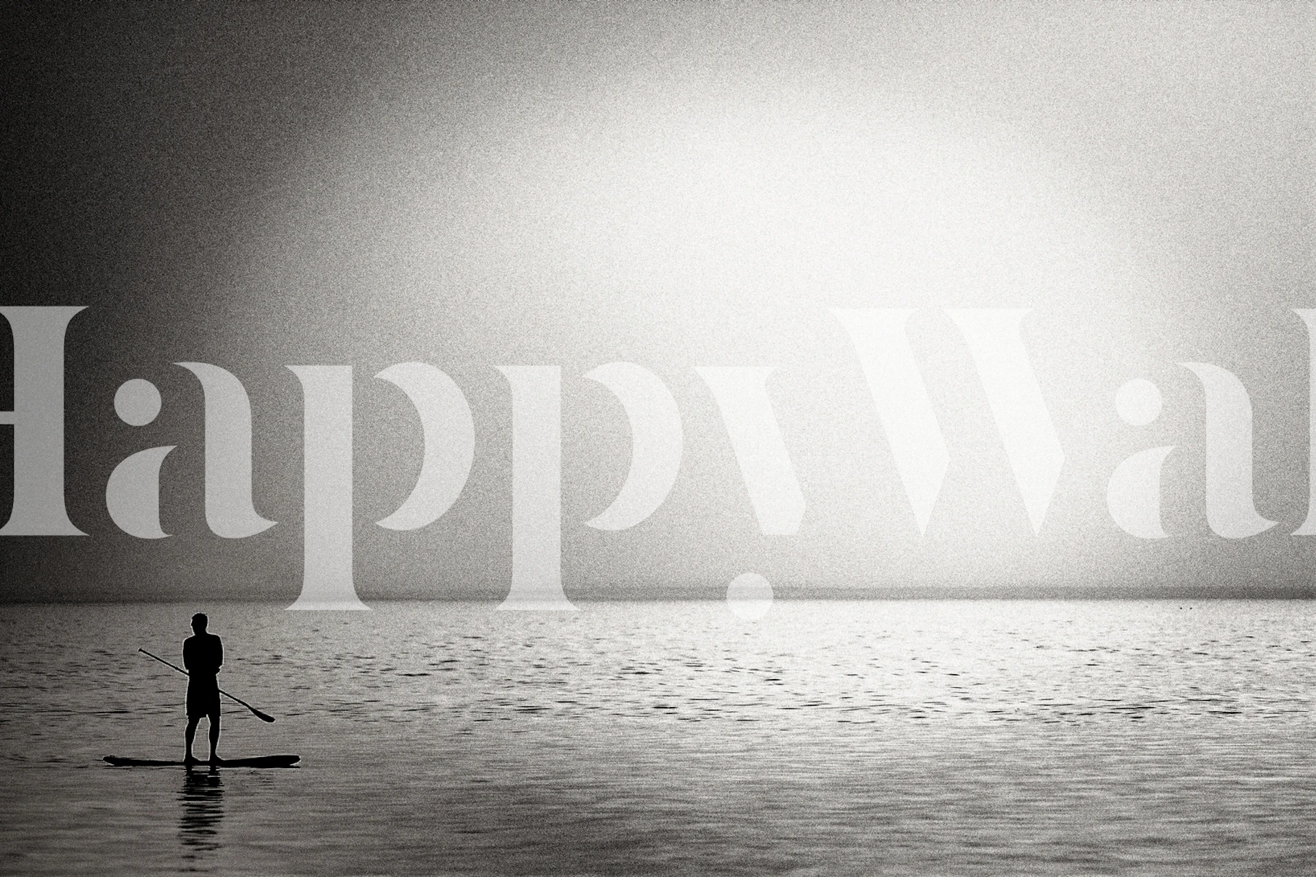 Black and white wallpaper featuring a person paddleboarding on a calm ocean at sunset