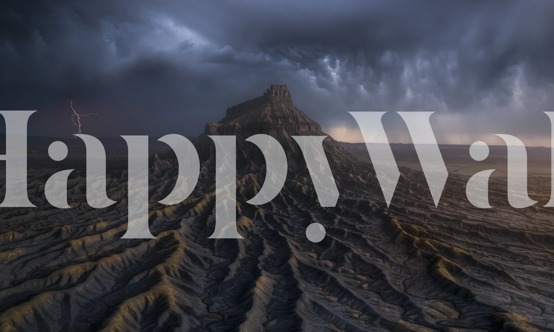 Dark mountain landscape wallpaper featuring jagged peaks and stormy sky
