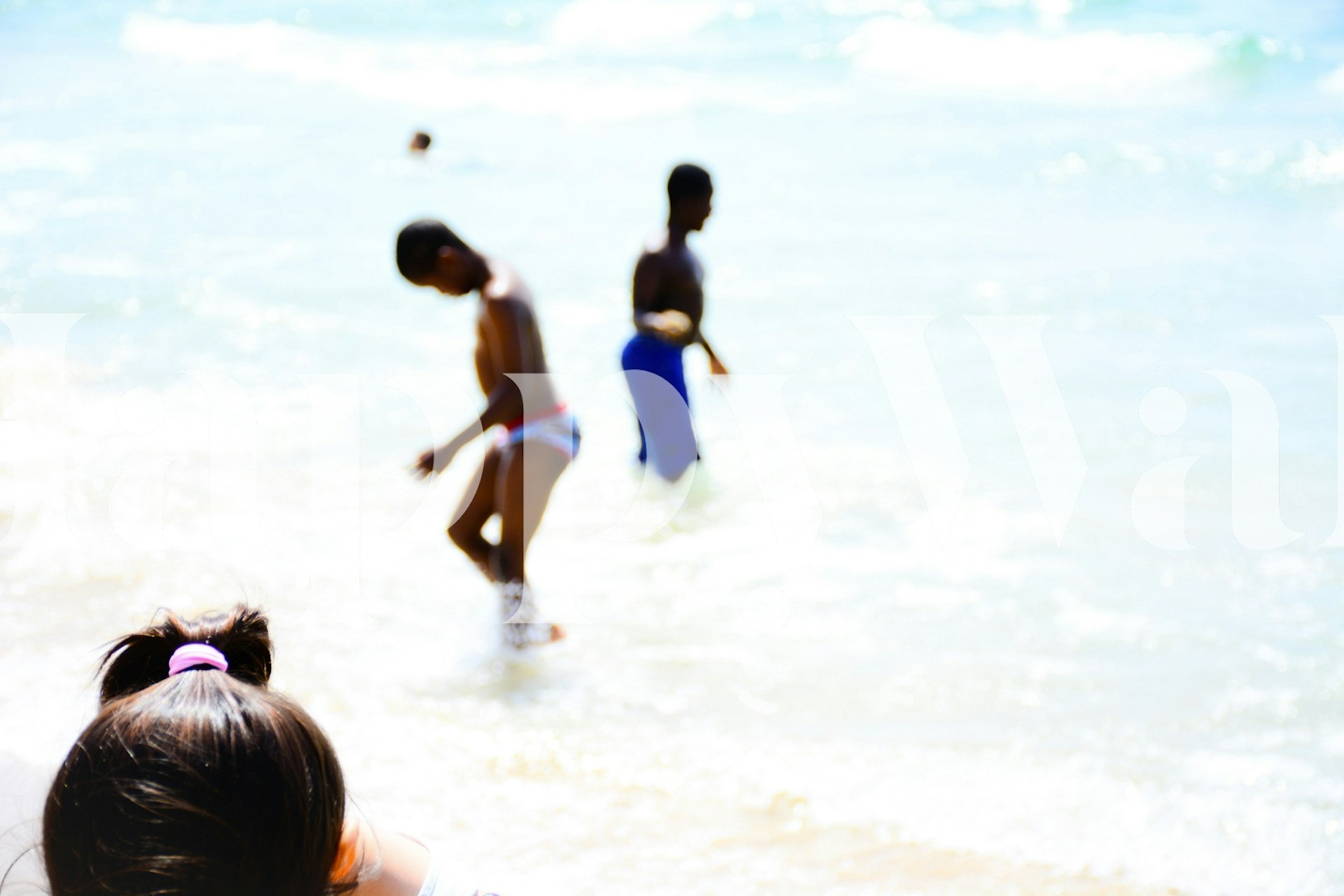 Beach scene wall mural with children playing and a sense of motion blur