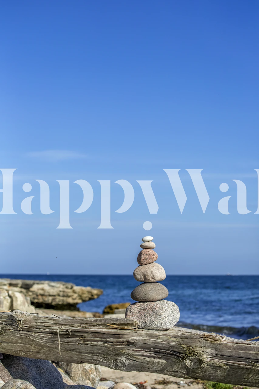 A stack of balanced stones on a serene Swedish beach wall mural