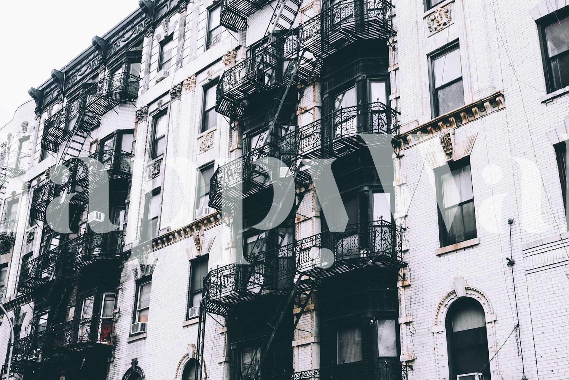 Buildings with fire escapes in black and white wallpaper