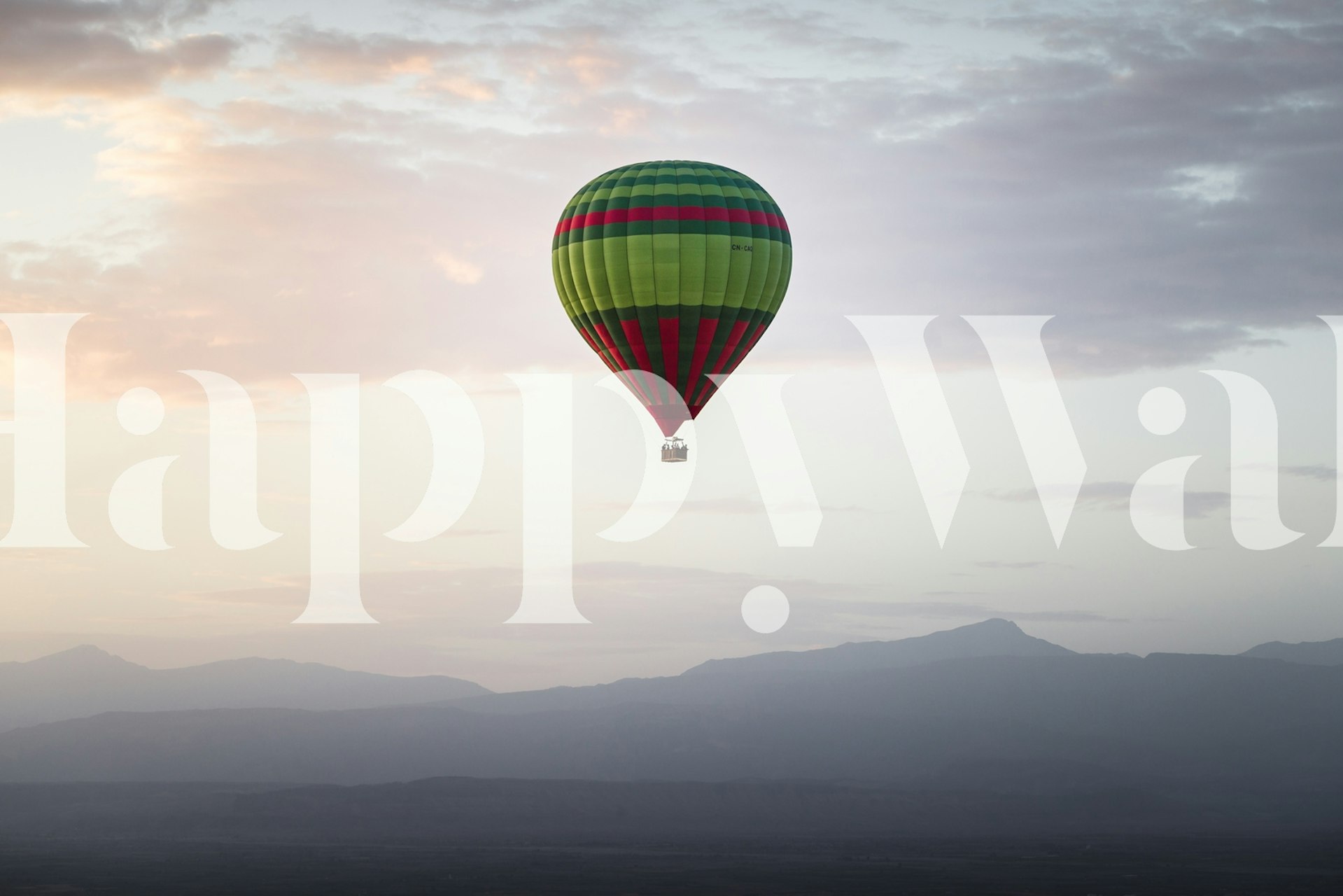Colorful hot air balloon with green and red stripes against a soft sky wallpaper