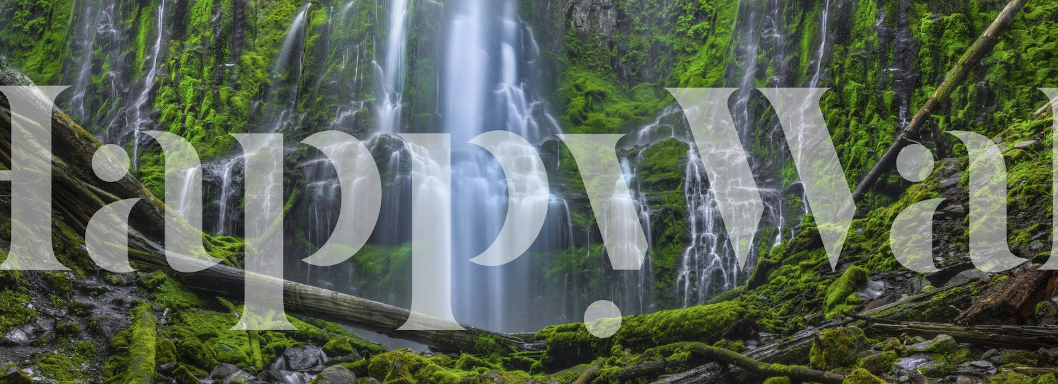 Lush green waterfall with rocky terrain wallpaper