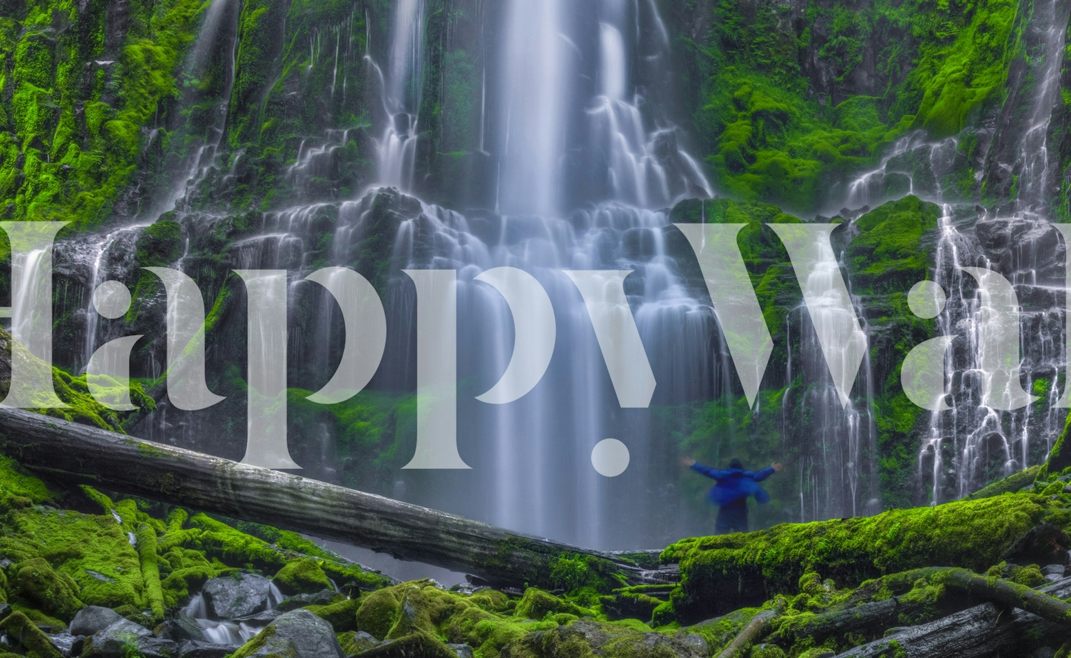 Waterfall cascading over rocks surrounded by green moss wallpaper