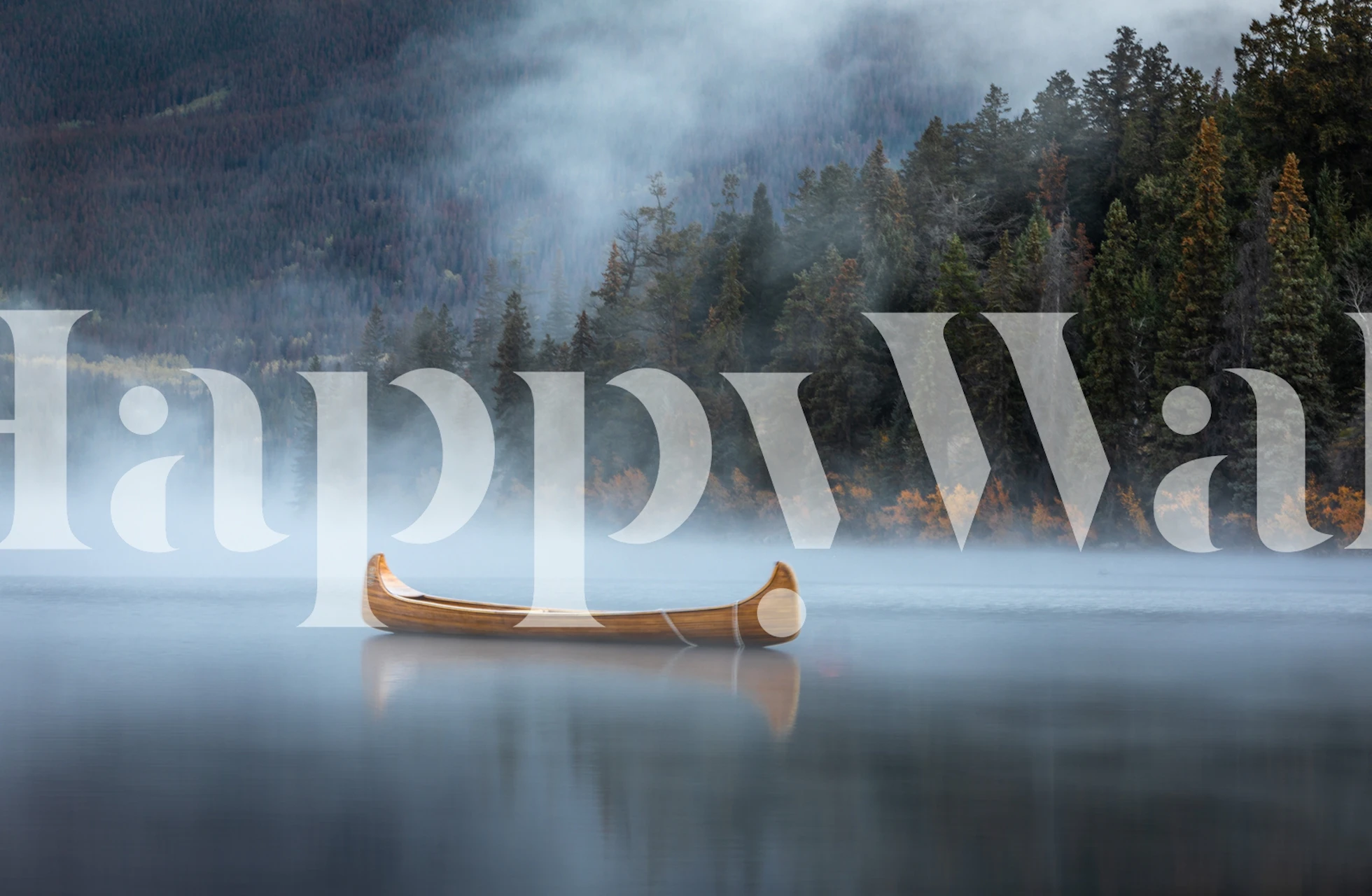 Canoe floating on a foggy lake surrounded by trees wallpaper