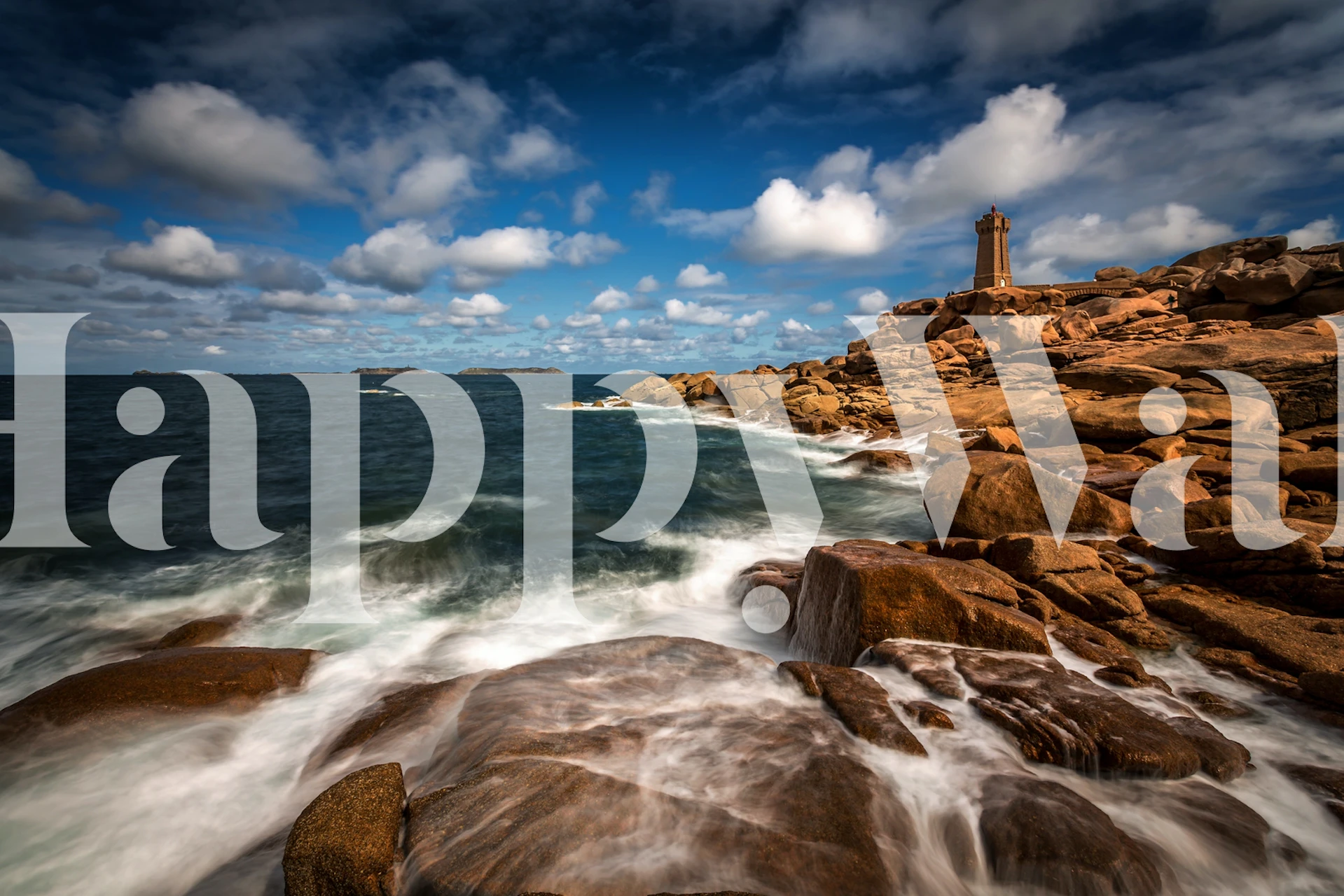 Ocean waves crashing on rocks with lighthouse and blue sky wallpaper