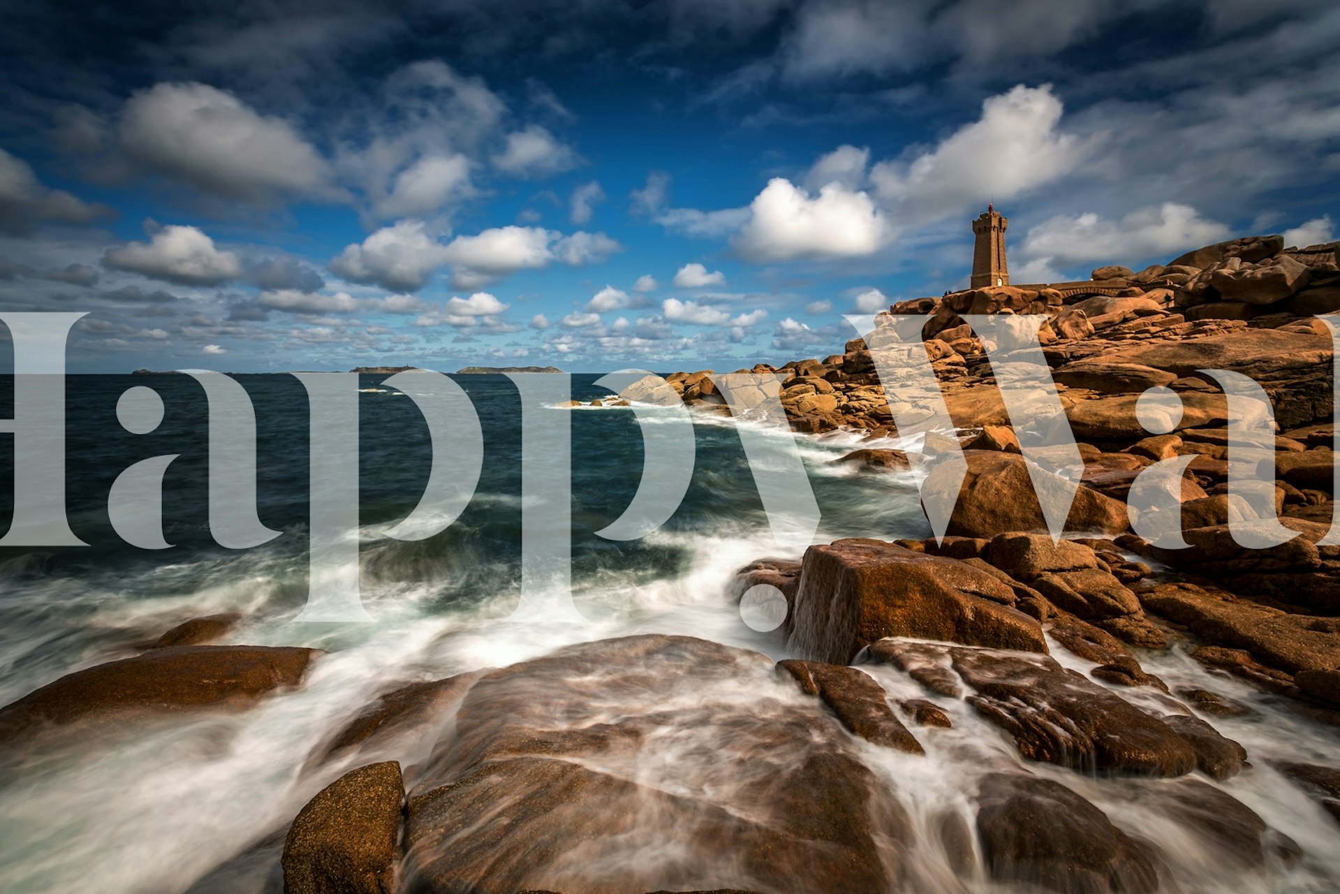 Ocean waves crashing on rocks with lighthouse and blue sky wallpaper