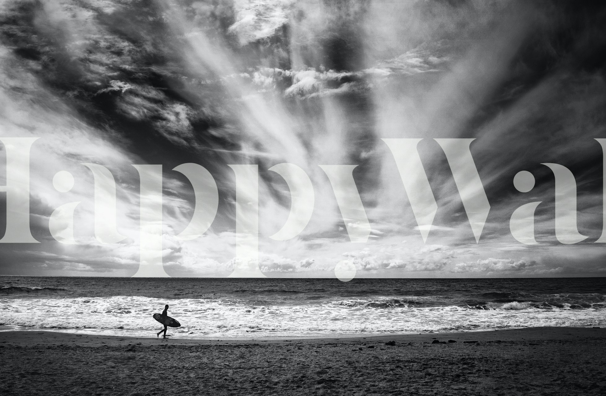 Surfer carrying a board on the beach with dramatic cloud patterns black and white wallpaper