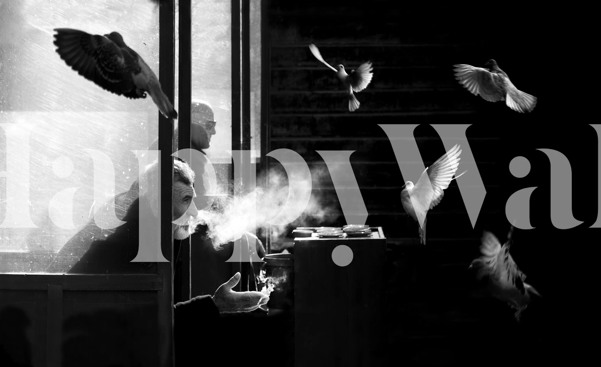 Black and white wallpaper with a man and pigeons