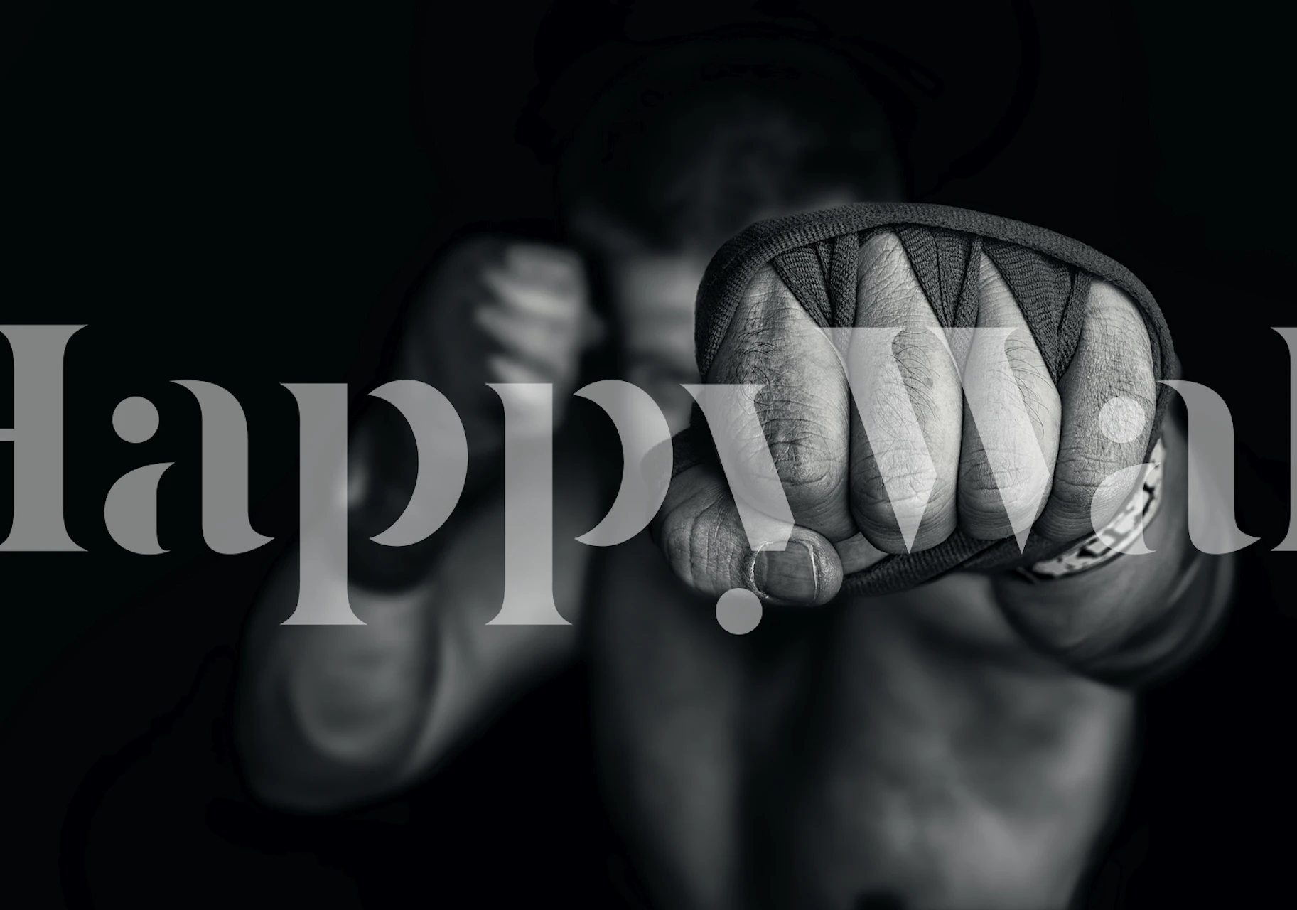 Black and white mural of a clenched fist representing strength and unity