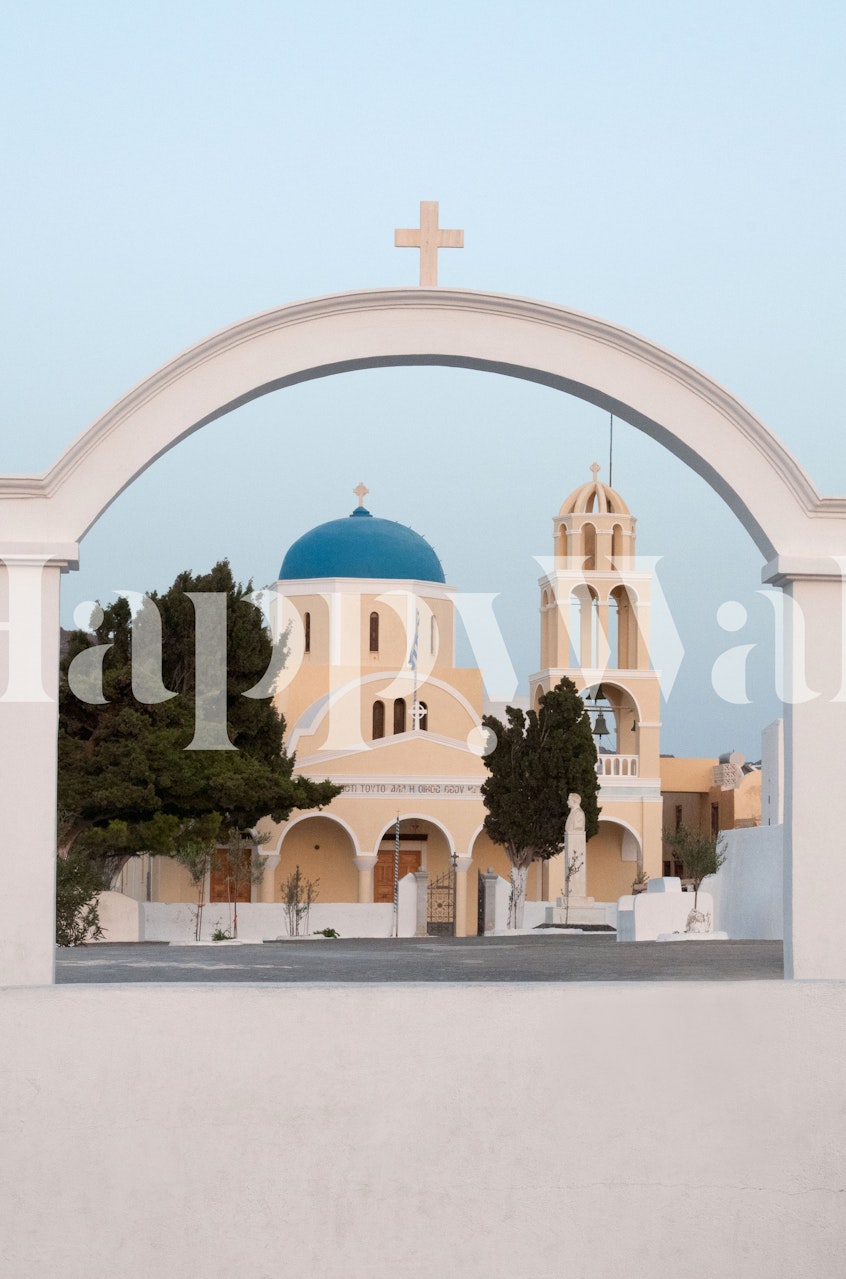 Santorini Oia village church with blue dome framed by an archway