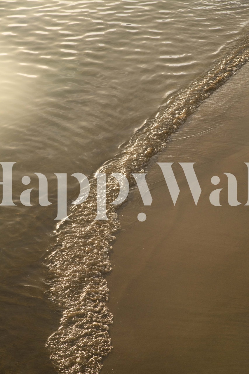 Golden sandy beach with gentle ocean waves wallpaper