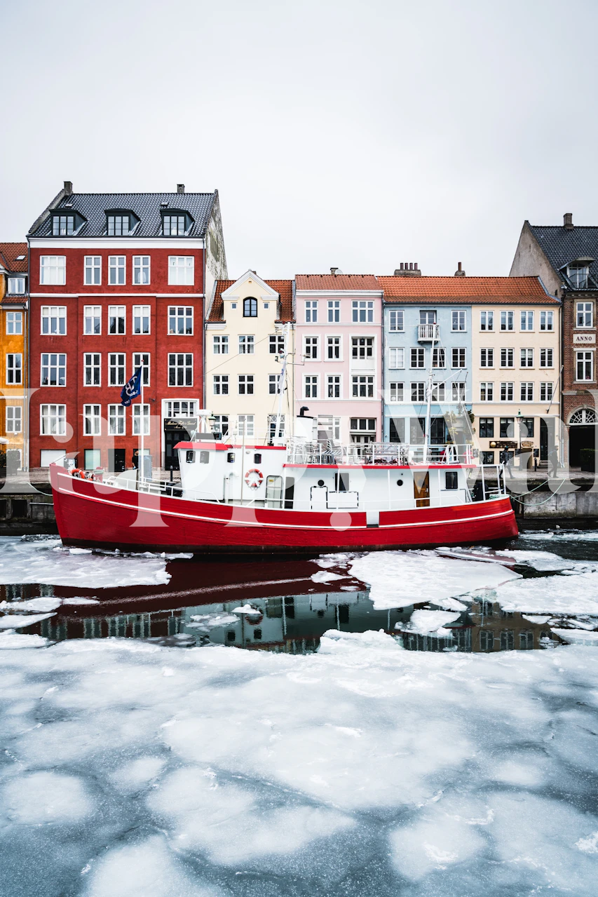 Colorful buildings and a red boat in icy waters wallpaper
