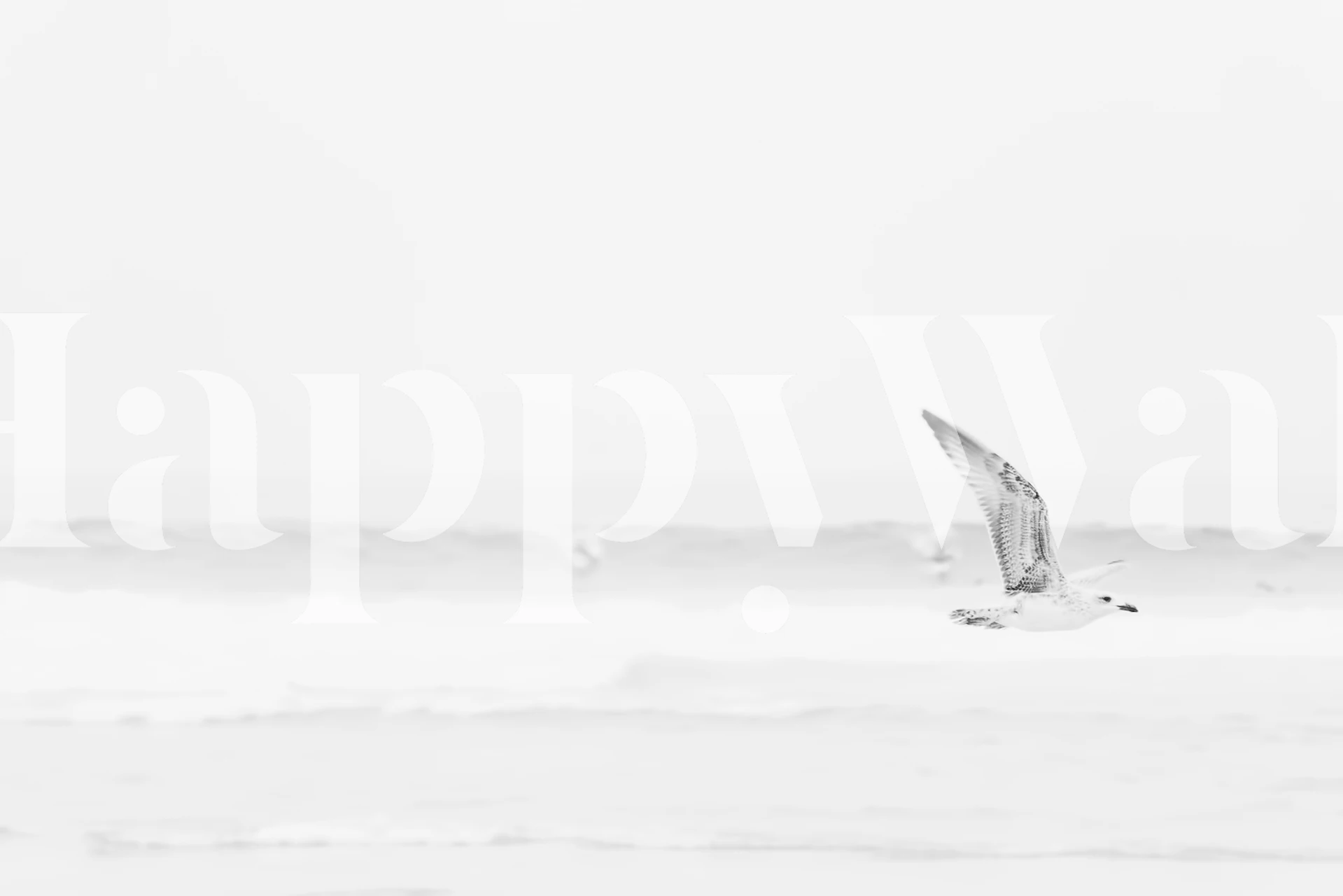 Svart og hvitt veggmaleri med havbølger og en flygende måke