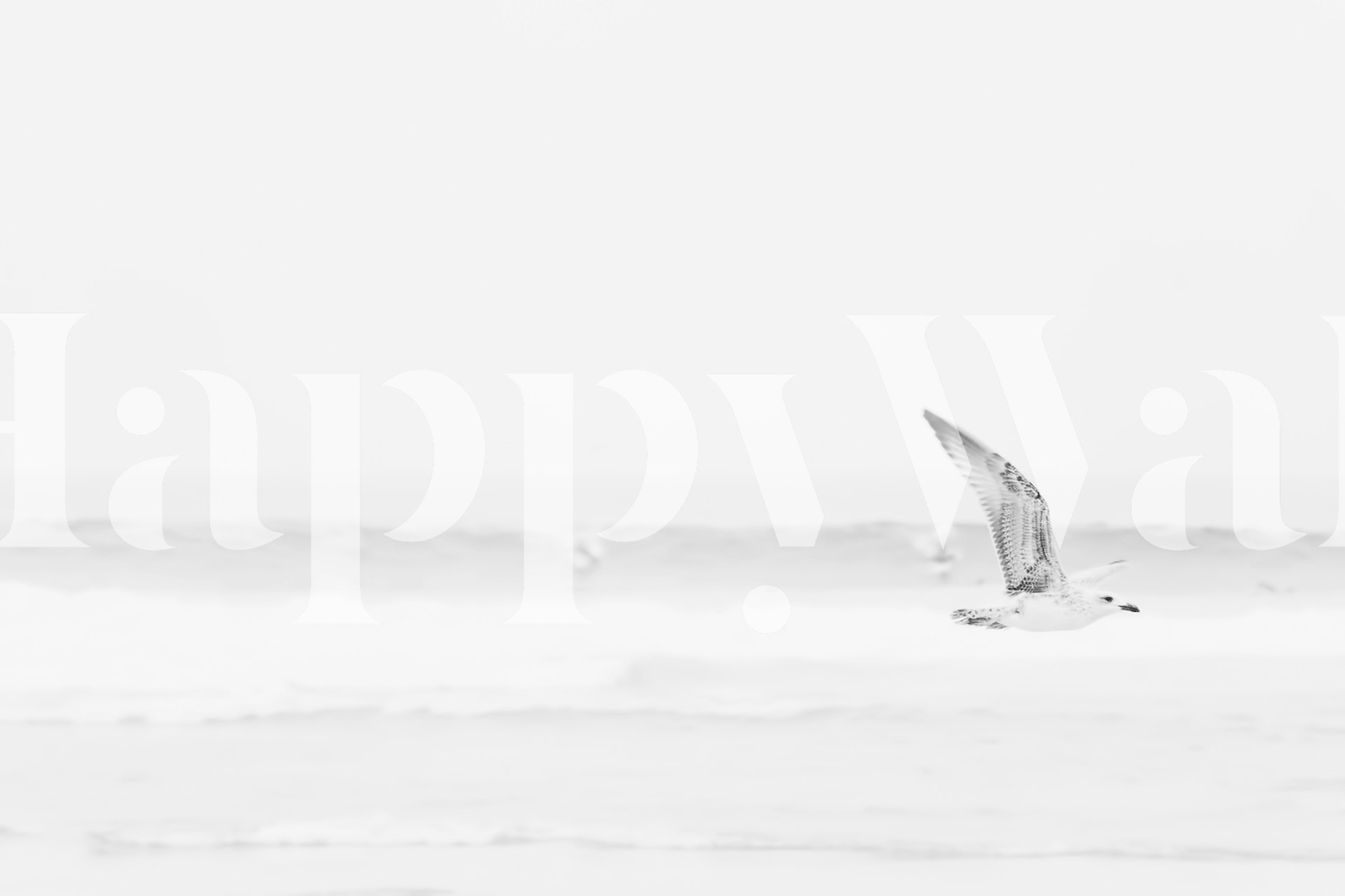 Black and white wall mural featuring ocean waves and a flying seagull