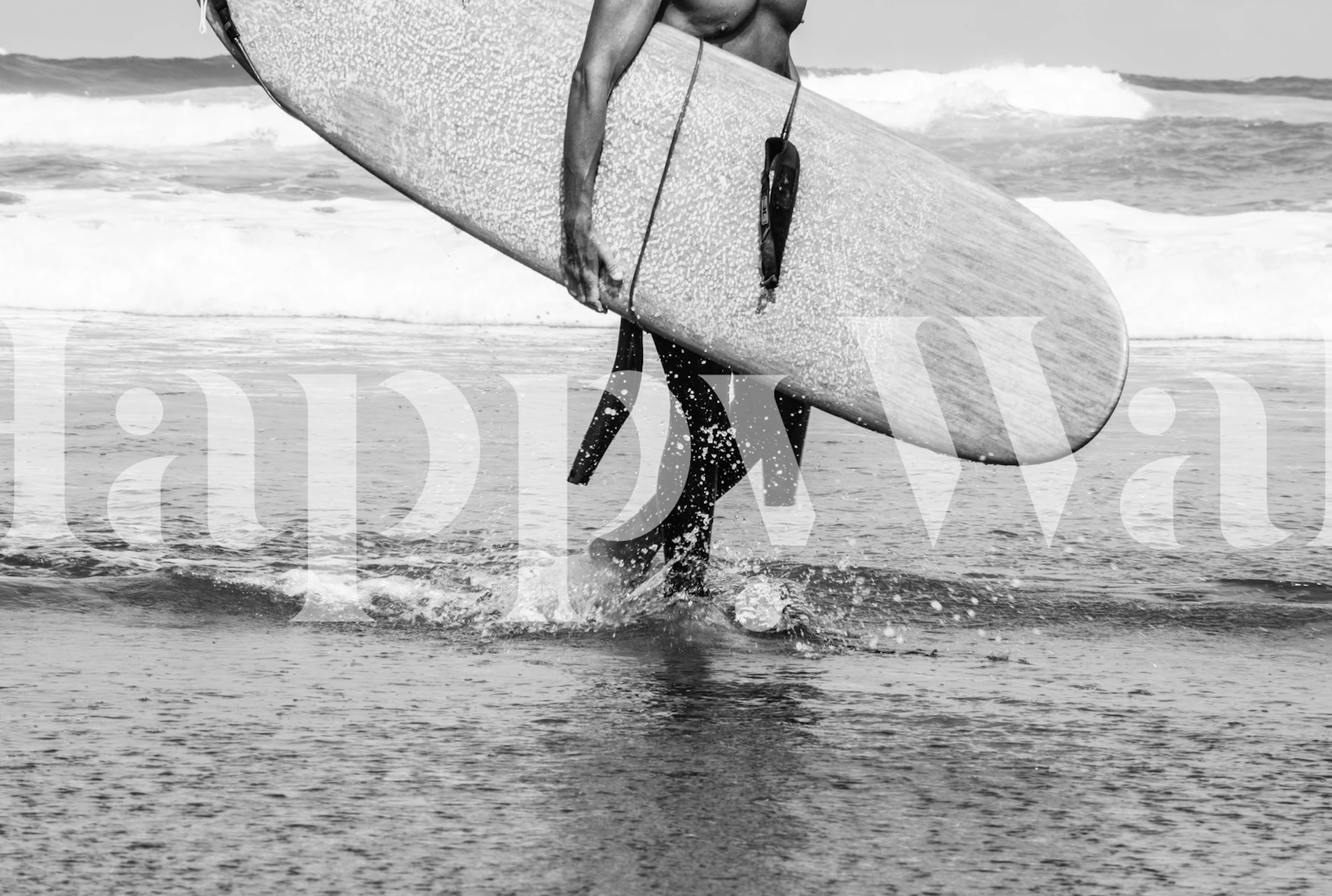 Black and white wall mural of a surfer walking by the sea with a surfboard