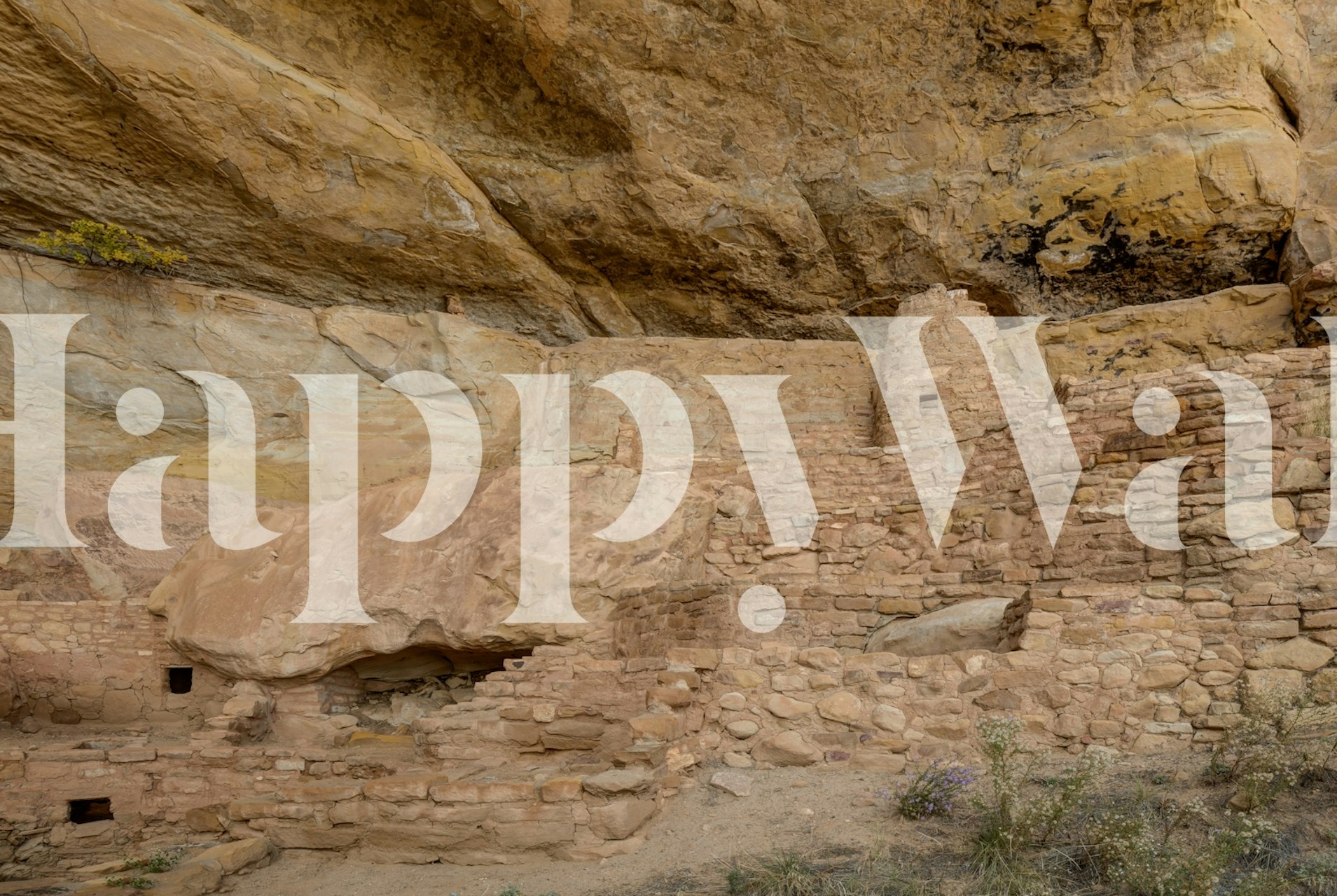 Ancient cliff dwelling ruins in earthy tones wallpaper