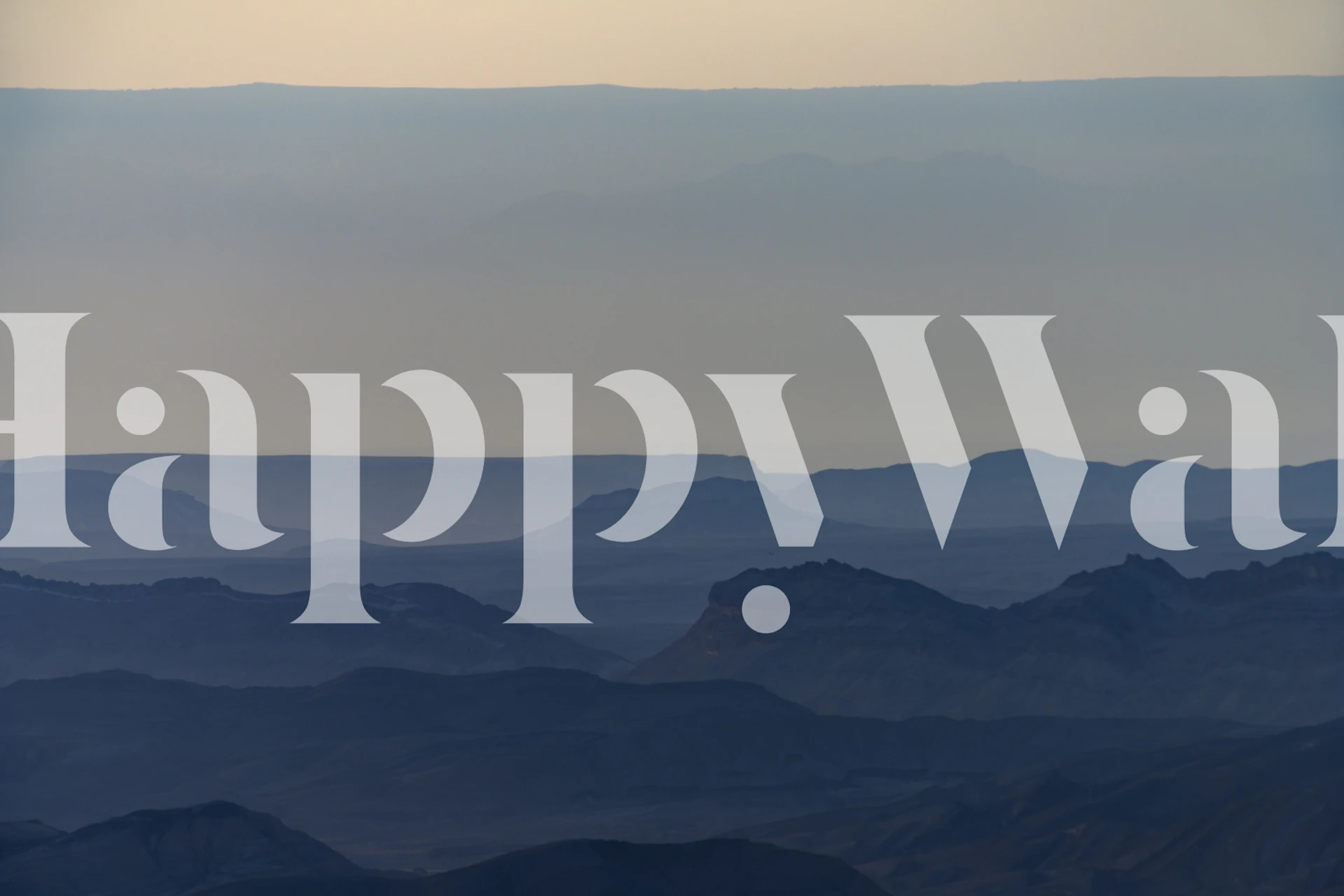 Landscape wallpaper featuring sunrise over mountains in soft blue hues