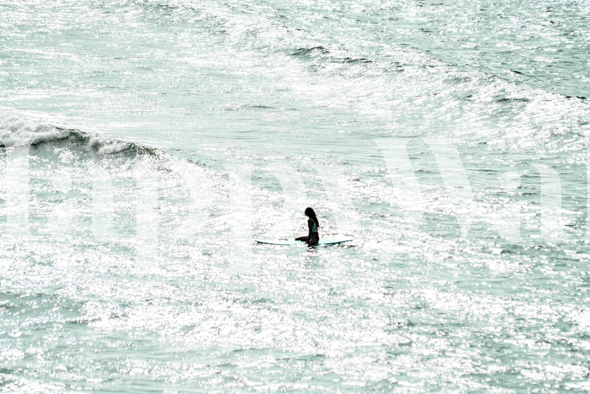 Wall mural of a lone surfer amidst vast ocean waves in Seaside 37.