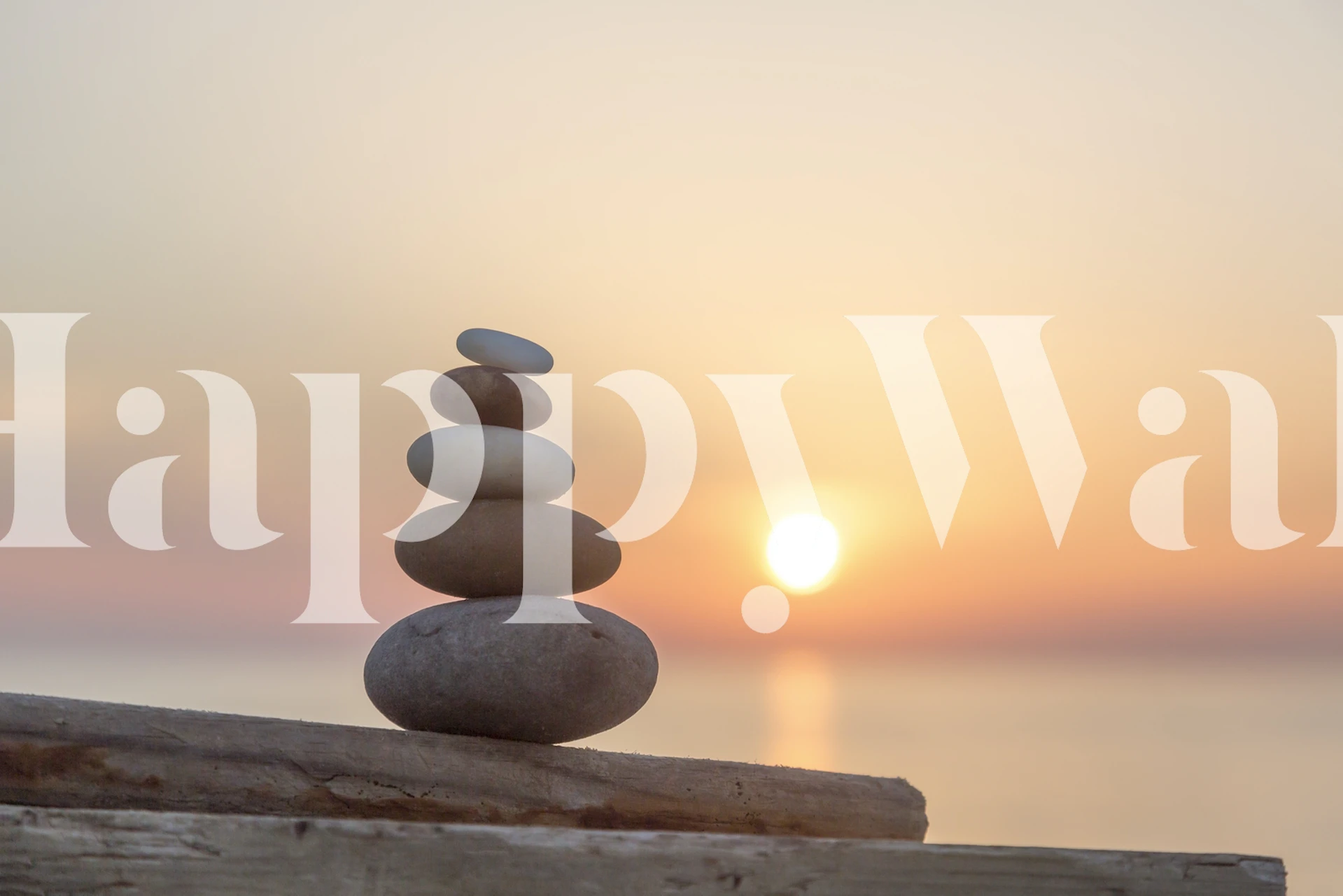 Stacked stones against a sunset background wallpaper