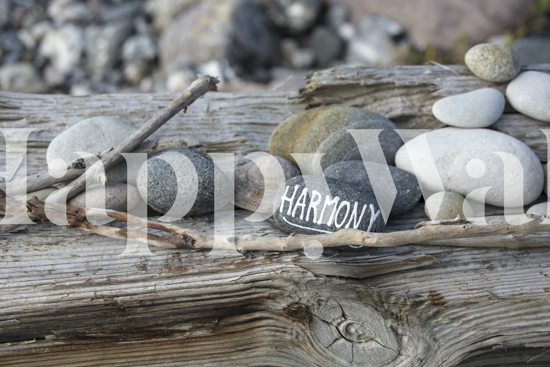 Smooth stones with 'HARMONY' text, grey and white colors, natural style wallpaper