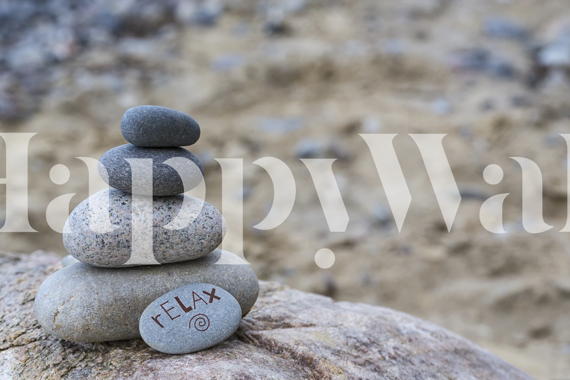 Stacked smooth stones with 'RELAX' inscribed on the bottom, natural colors wallpaper