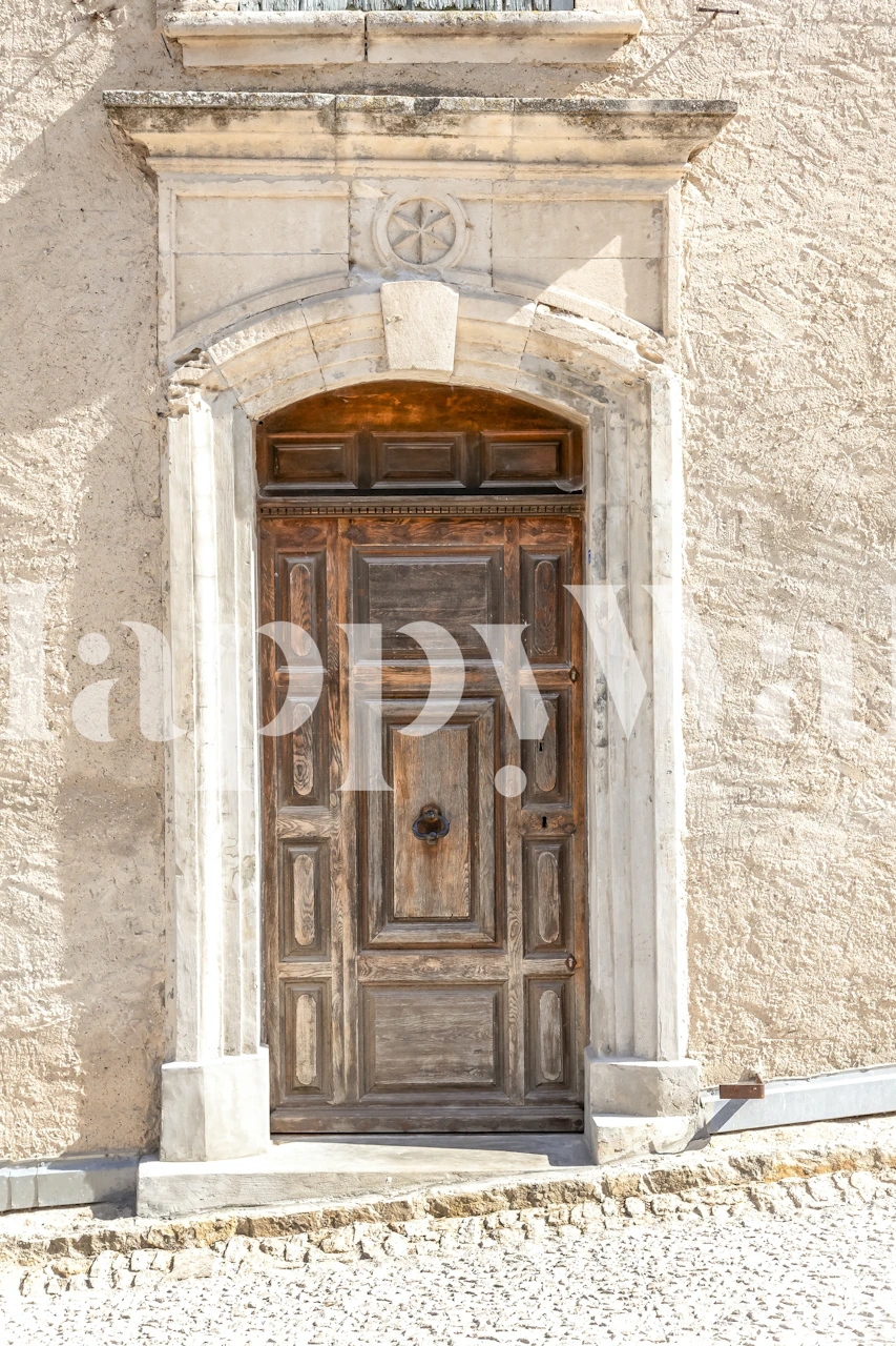Old weathered wooden door with arch detail on textured wall wallpaper