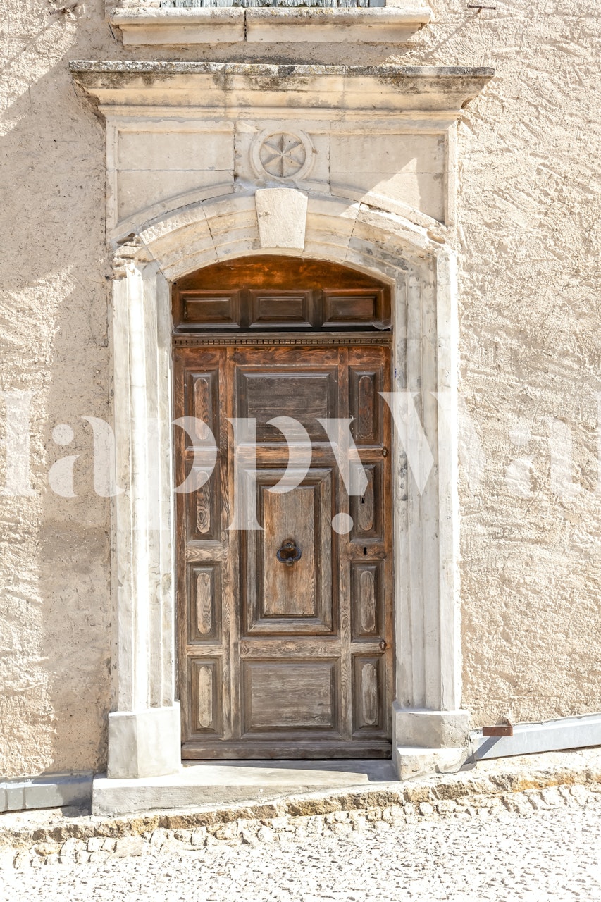 Old weathered wooden door with arch detail on textured wall wallpaper