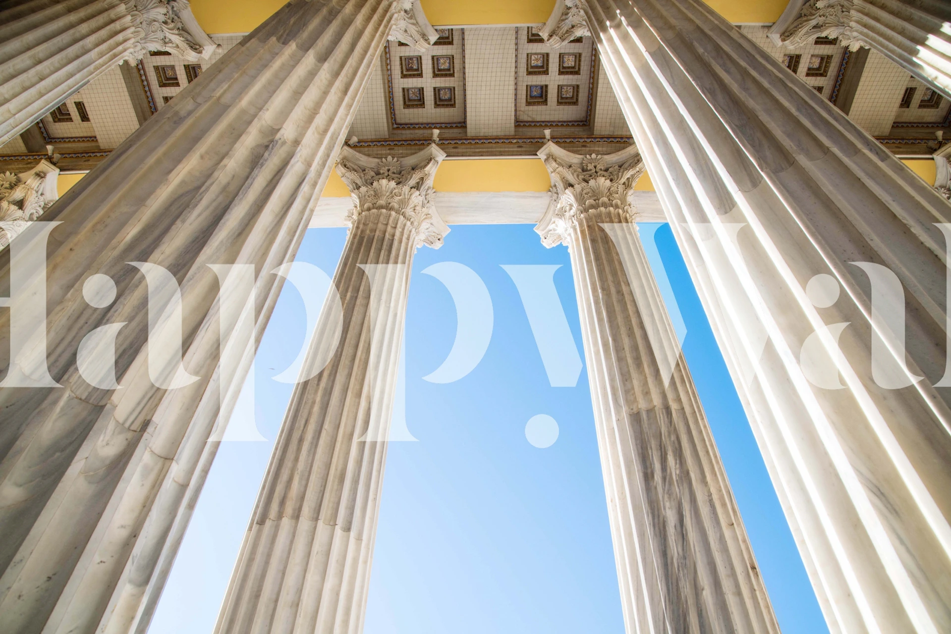 Marble columns in a room with blue sky view