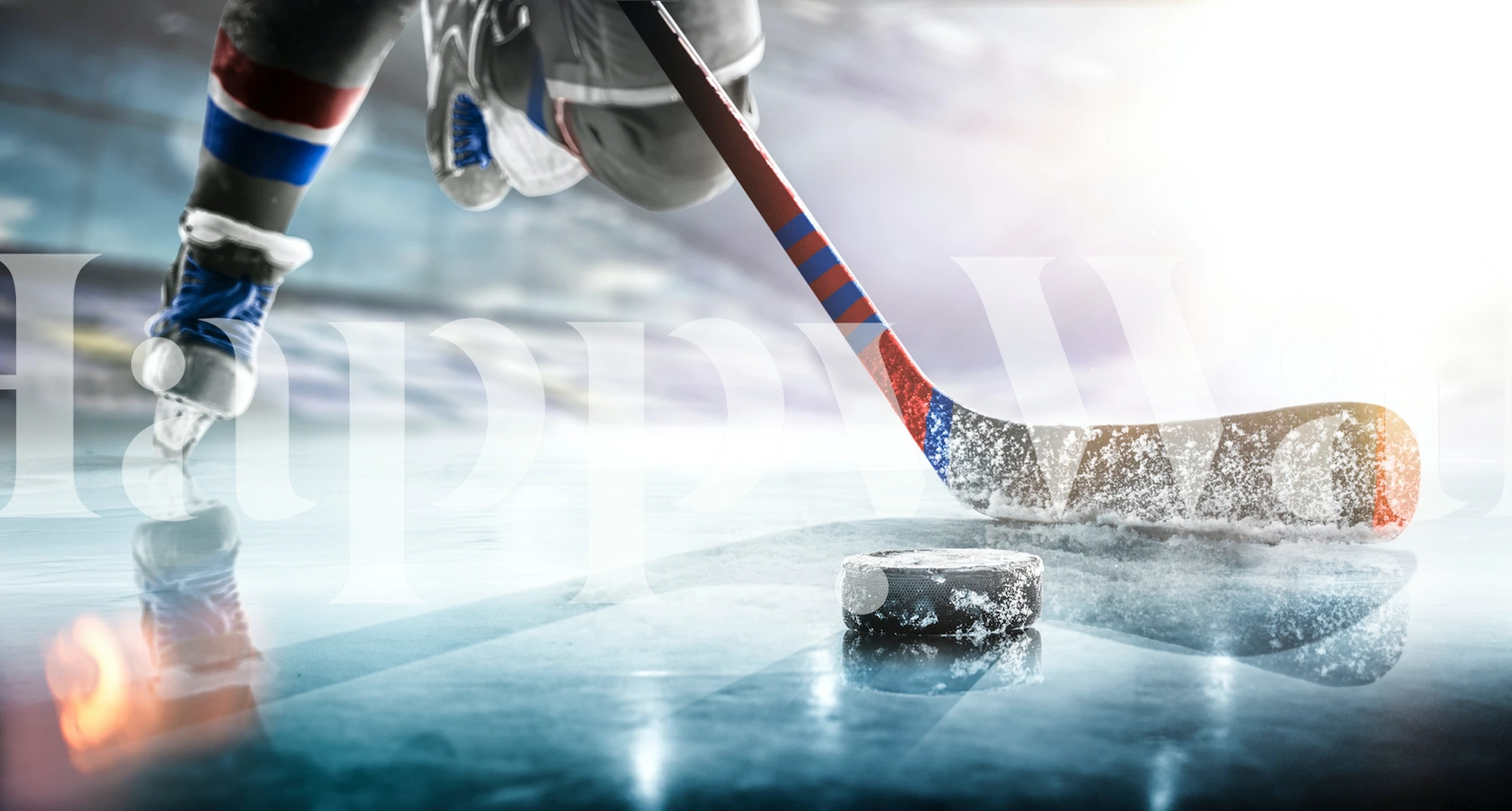 Ice hockey player in action with puck on ice wallpaper