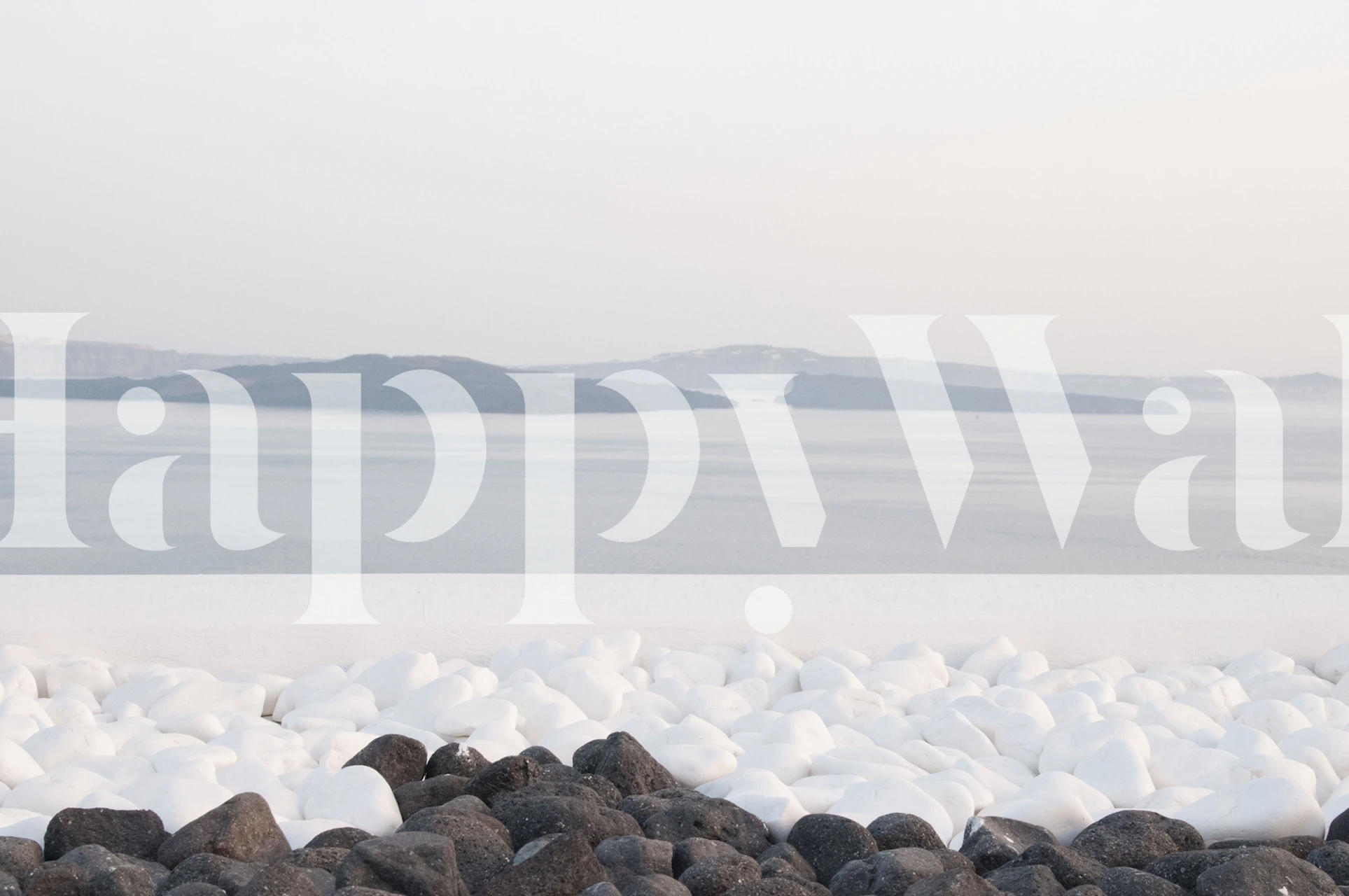 Santorini-inspired wall mural with pebbles and hazy island horizon