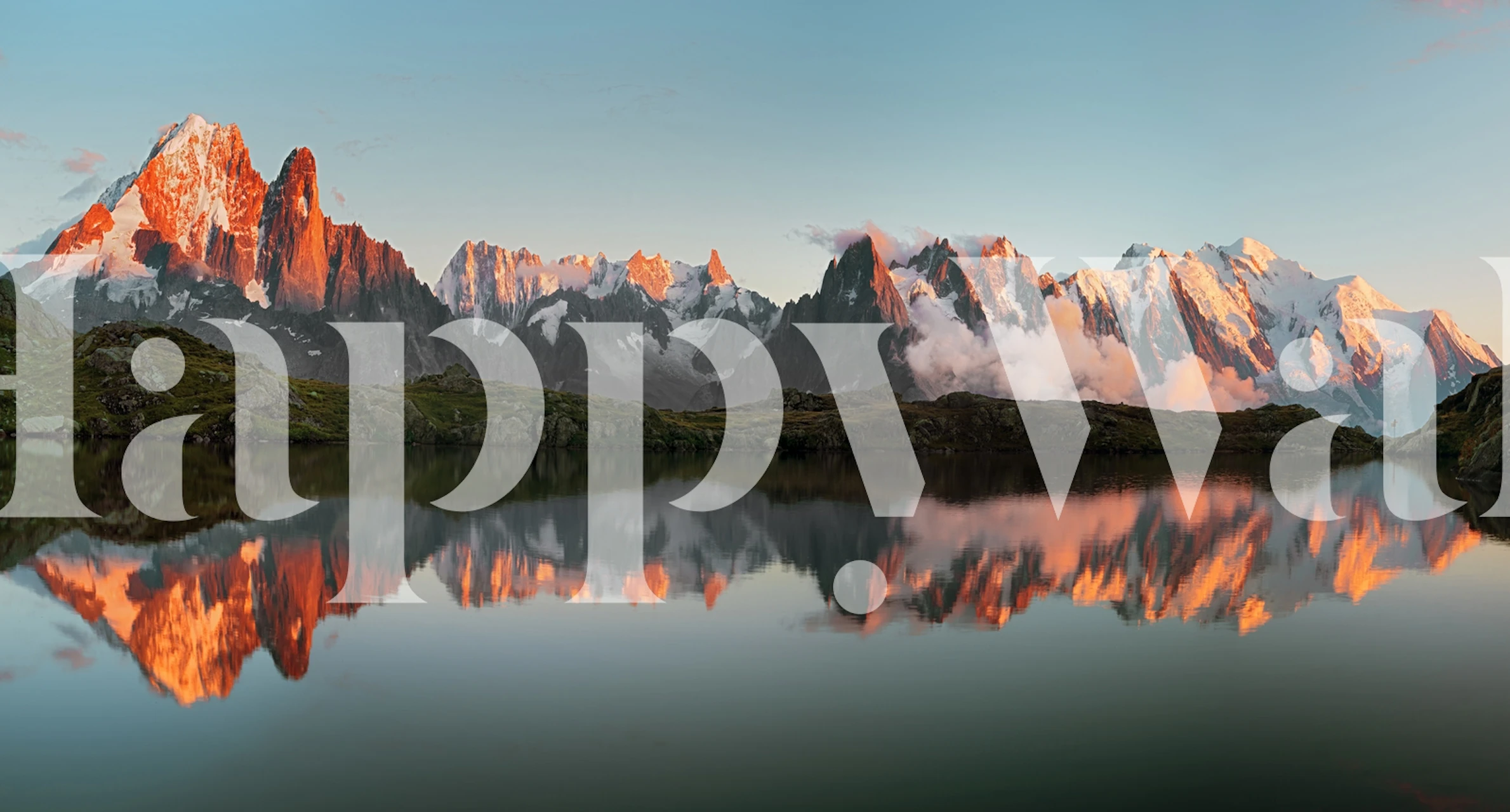Mountain landscape with a sunset reflecting on a lake wallpaper