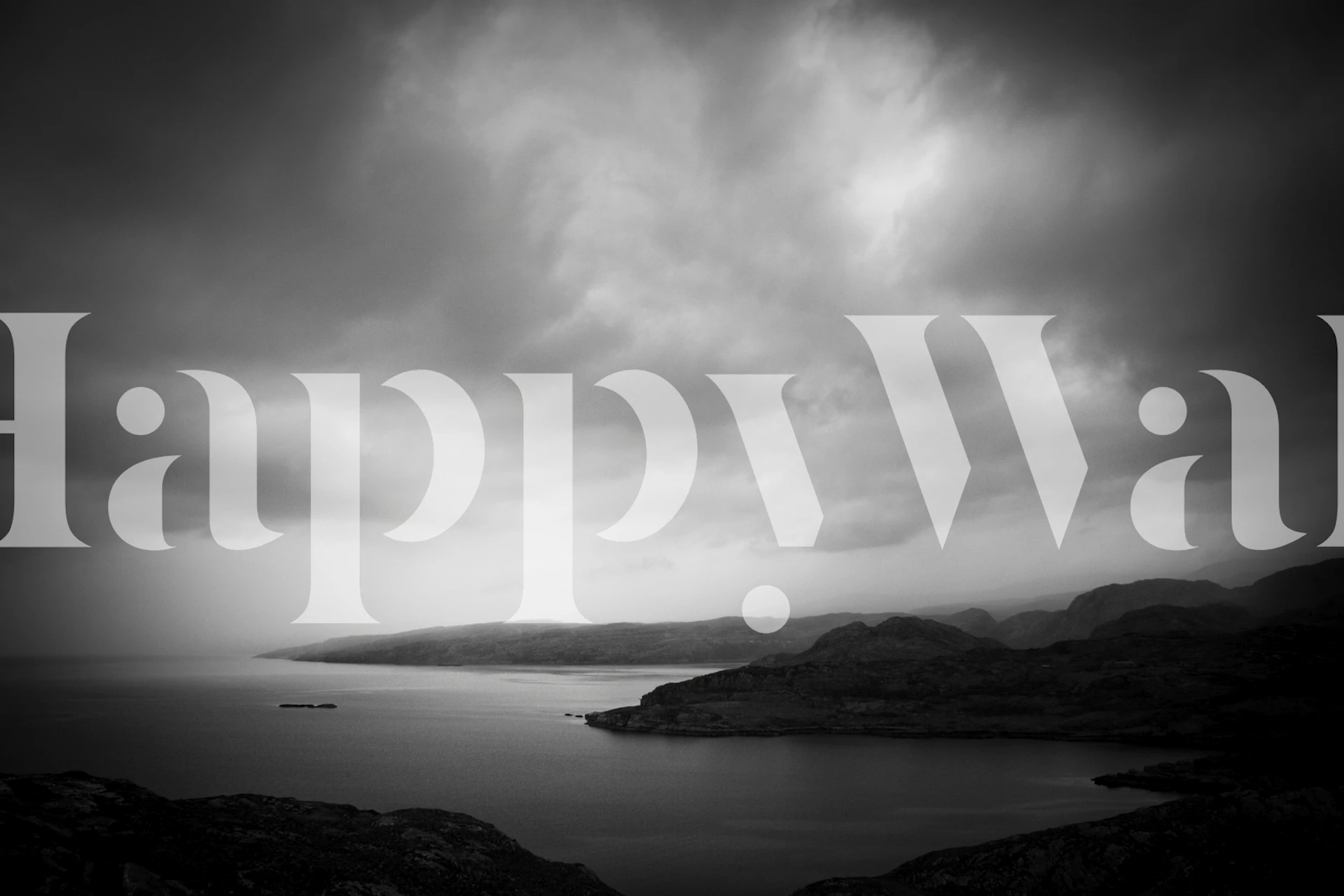 Monochrome landscape with dark rocks and cloudy sky wallpaper