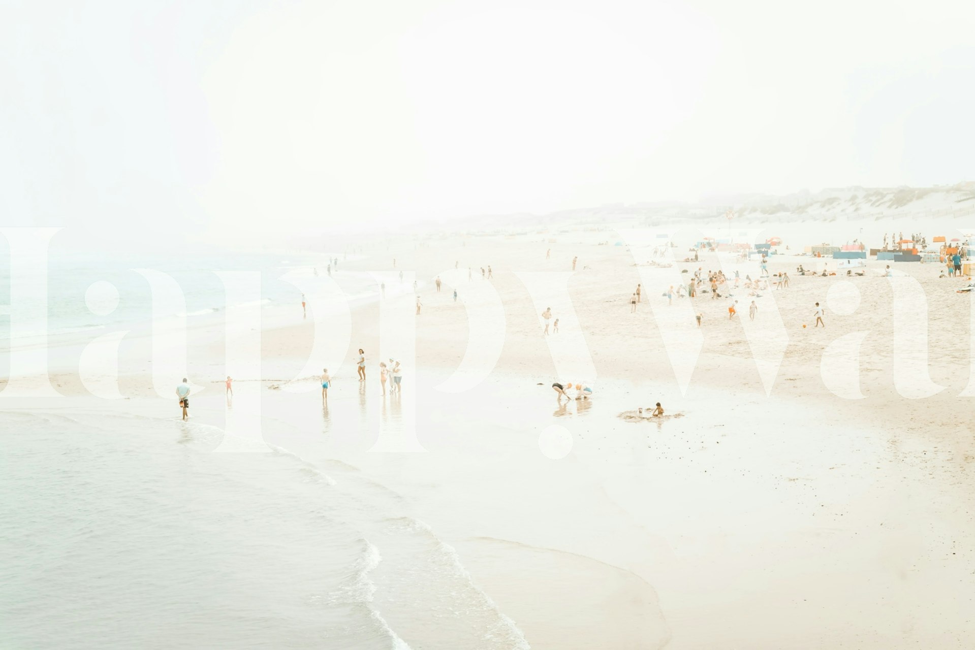 Beach scene wallpaper featuring sandy shore, ocean, and people.