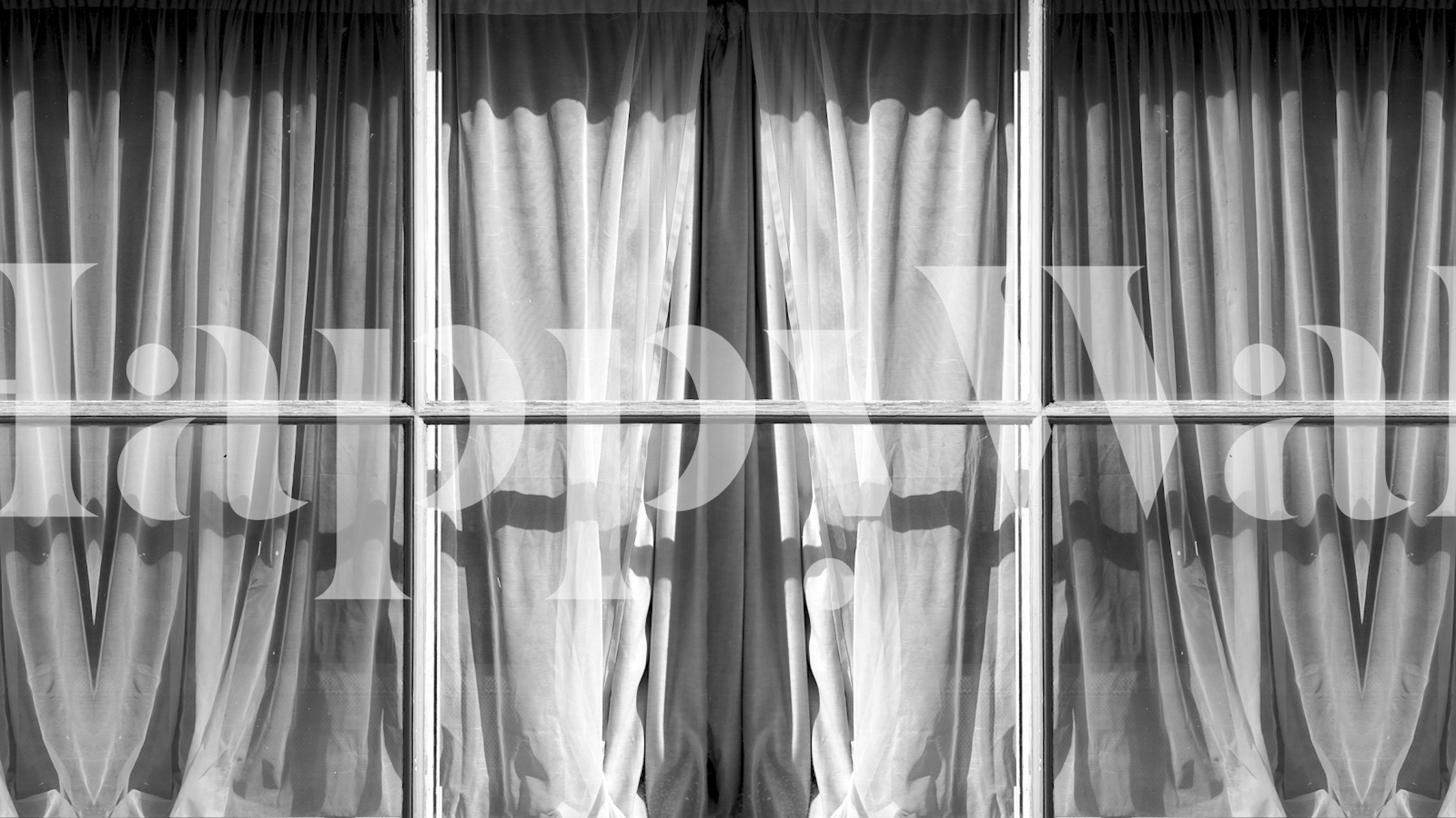 Black and white patterned wallpaper featuring window curtains.
