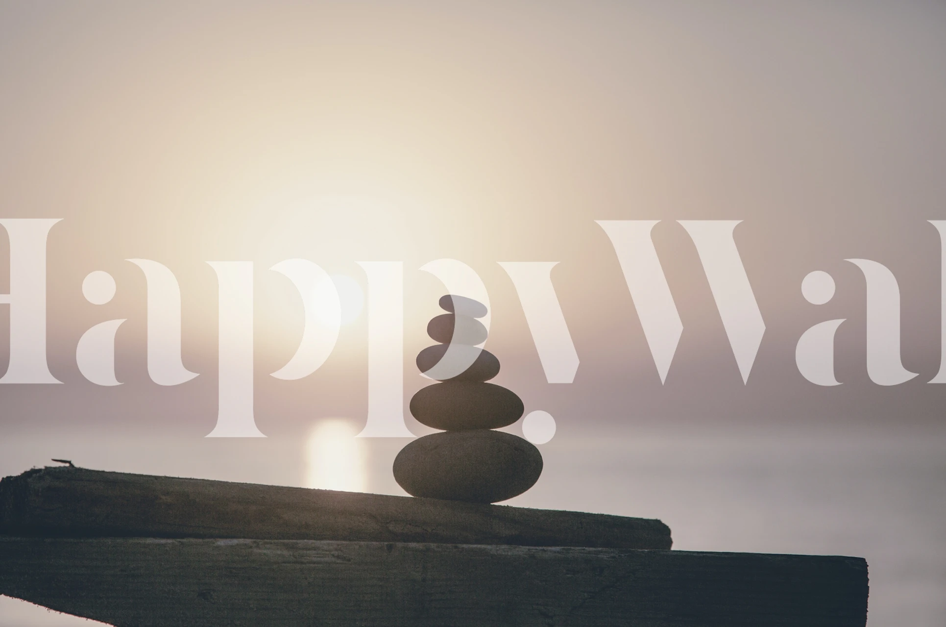 Stacked stones silhouette against a sunset backdrop wallpaper