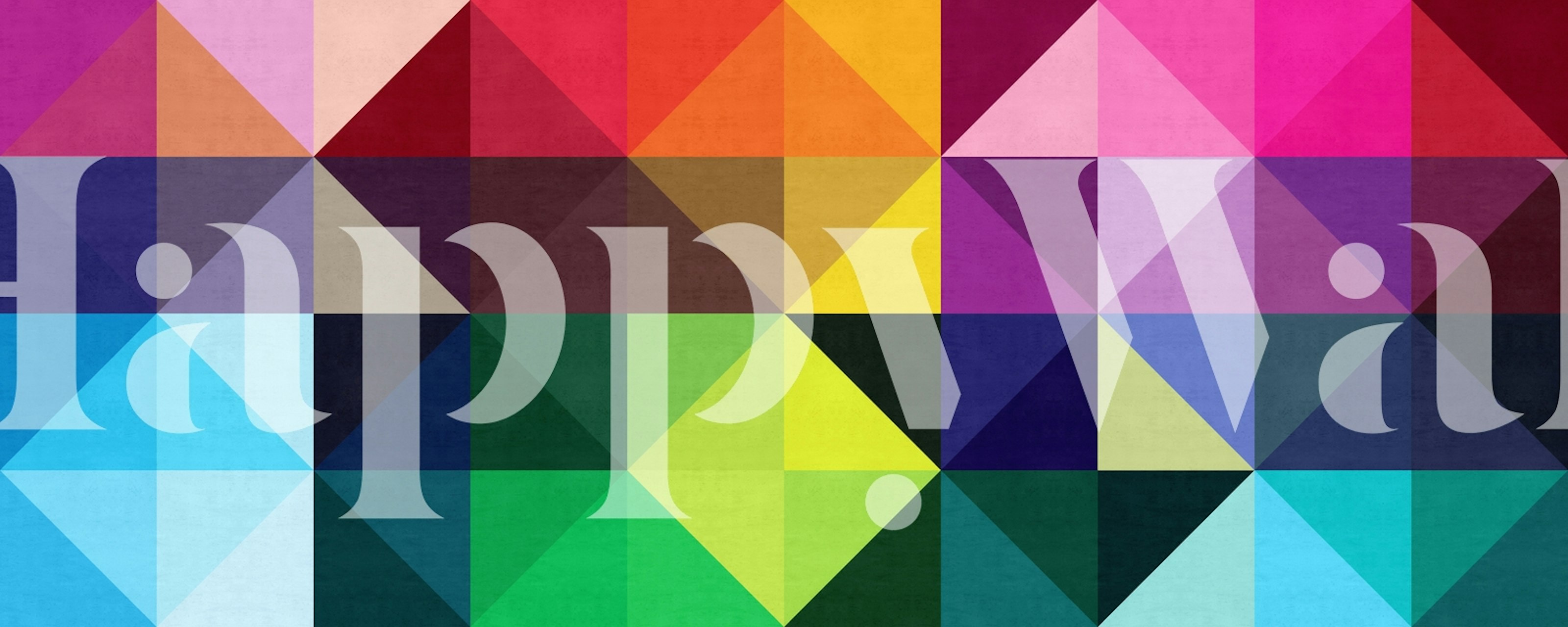 Colorful geometric triangles in various shades of red, blue, green, purple, and yellow wallpaper