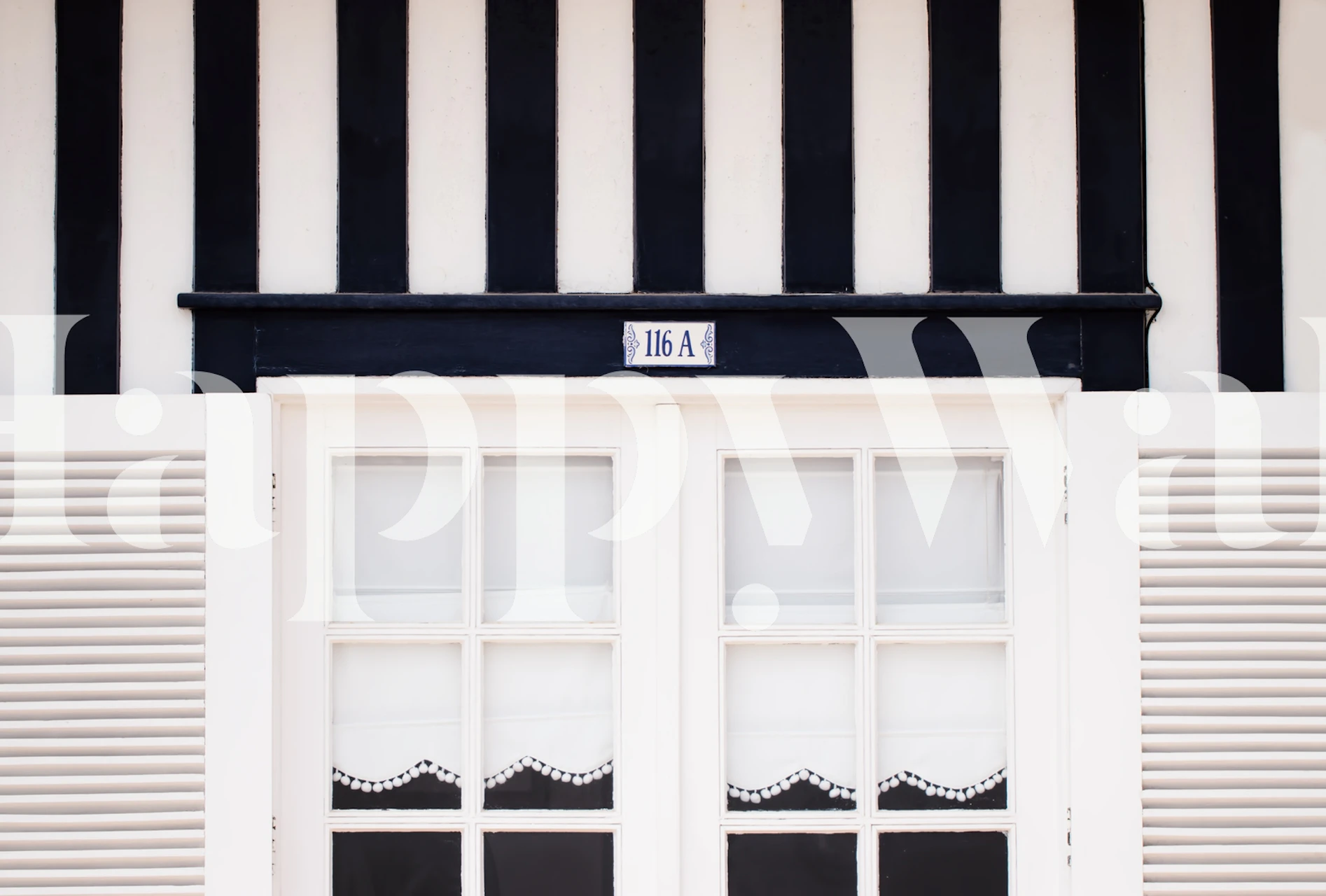 Black and white vertical striped wallpaper with window design