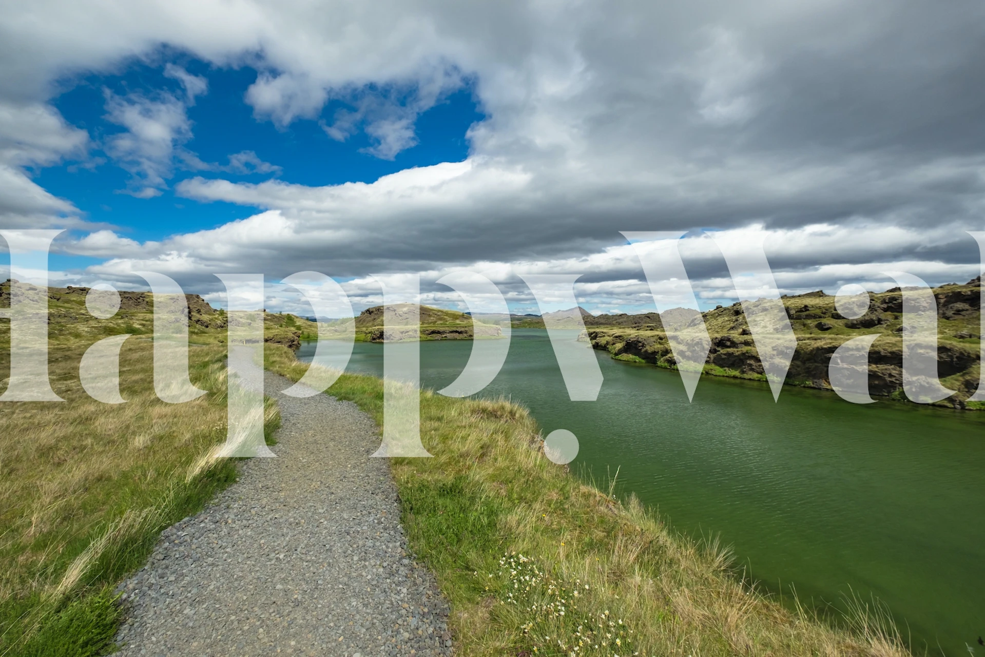 Scenic landscape with a path, green water, rocks, and clouds wallpaper