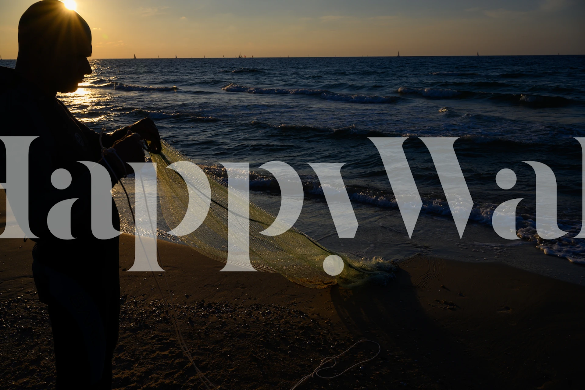 Fisherman at sunset by the ocean