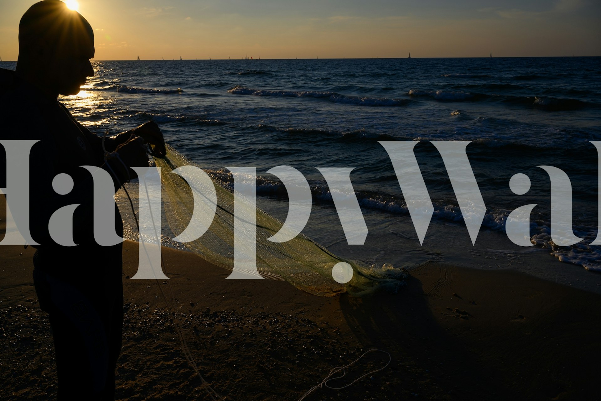 Fisherman at sunset by the ocean