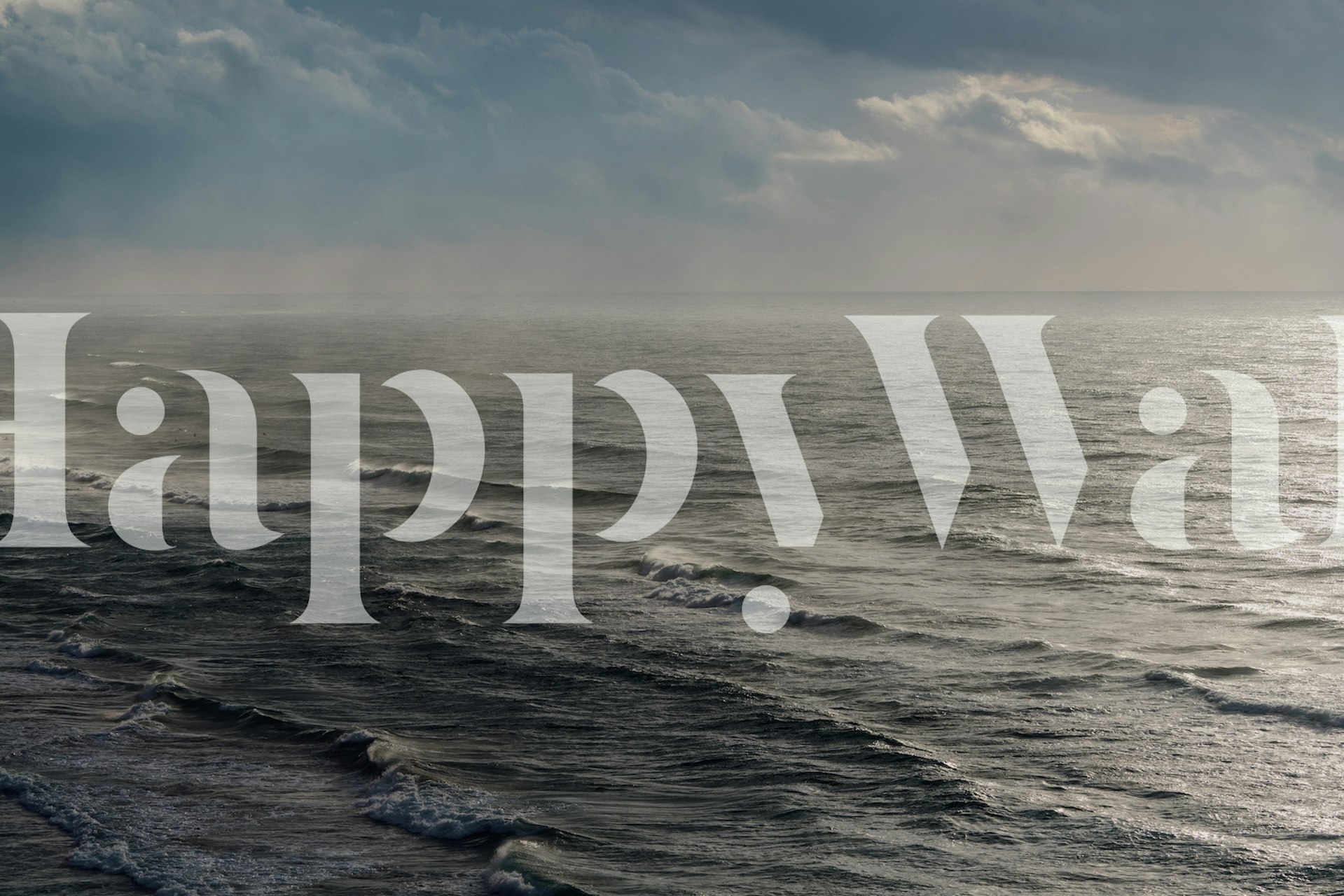 Ocean waves under cloudy sky in blue and gray wallpaper