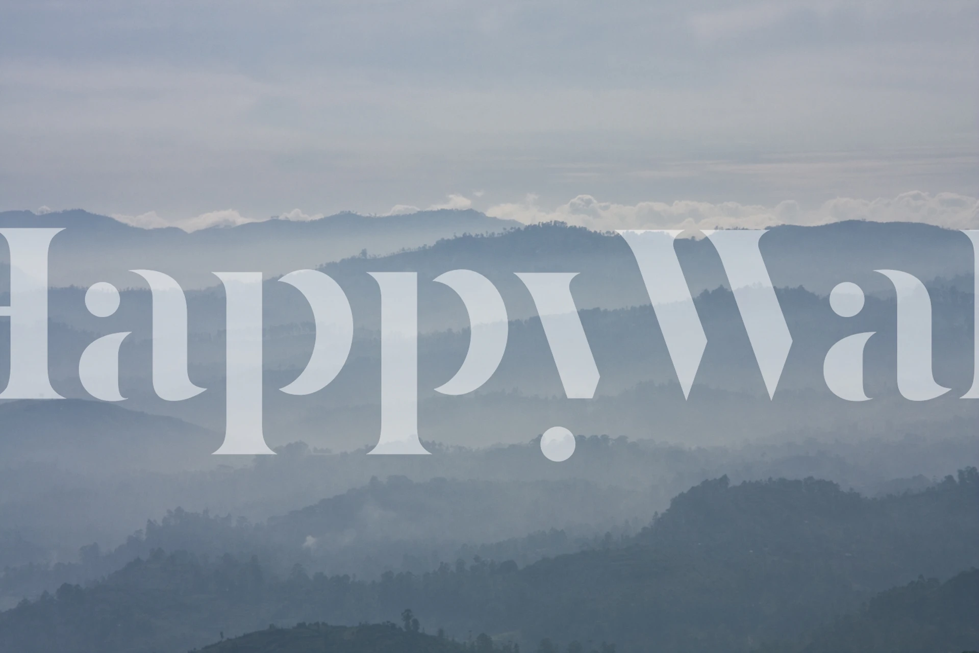 Foggy mountain landscape in blue tones wallpaper