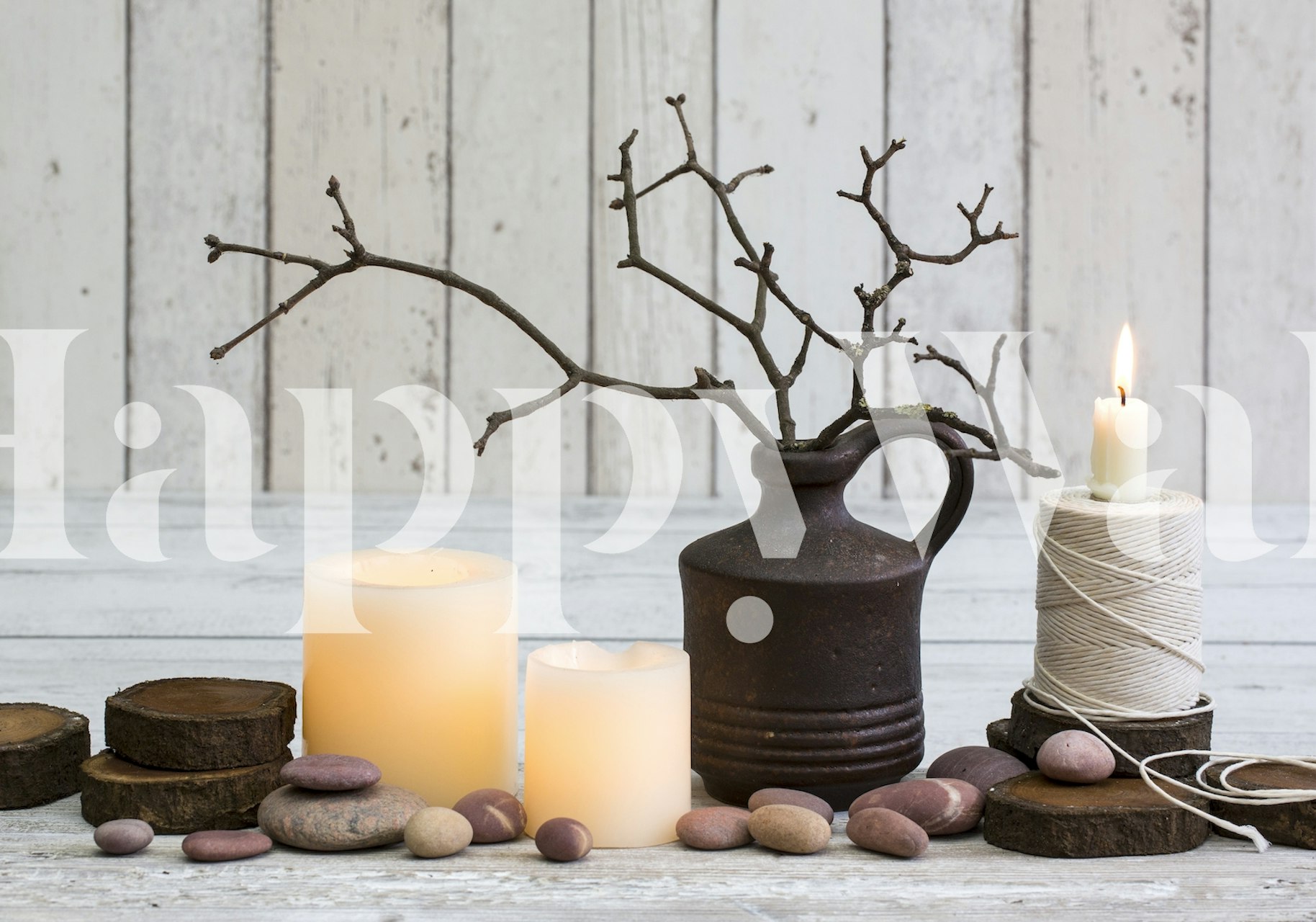 Rustic candle arrangement with stones and branches on a wooden background wallpaper