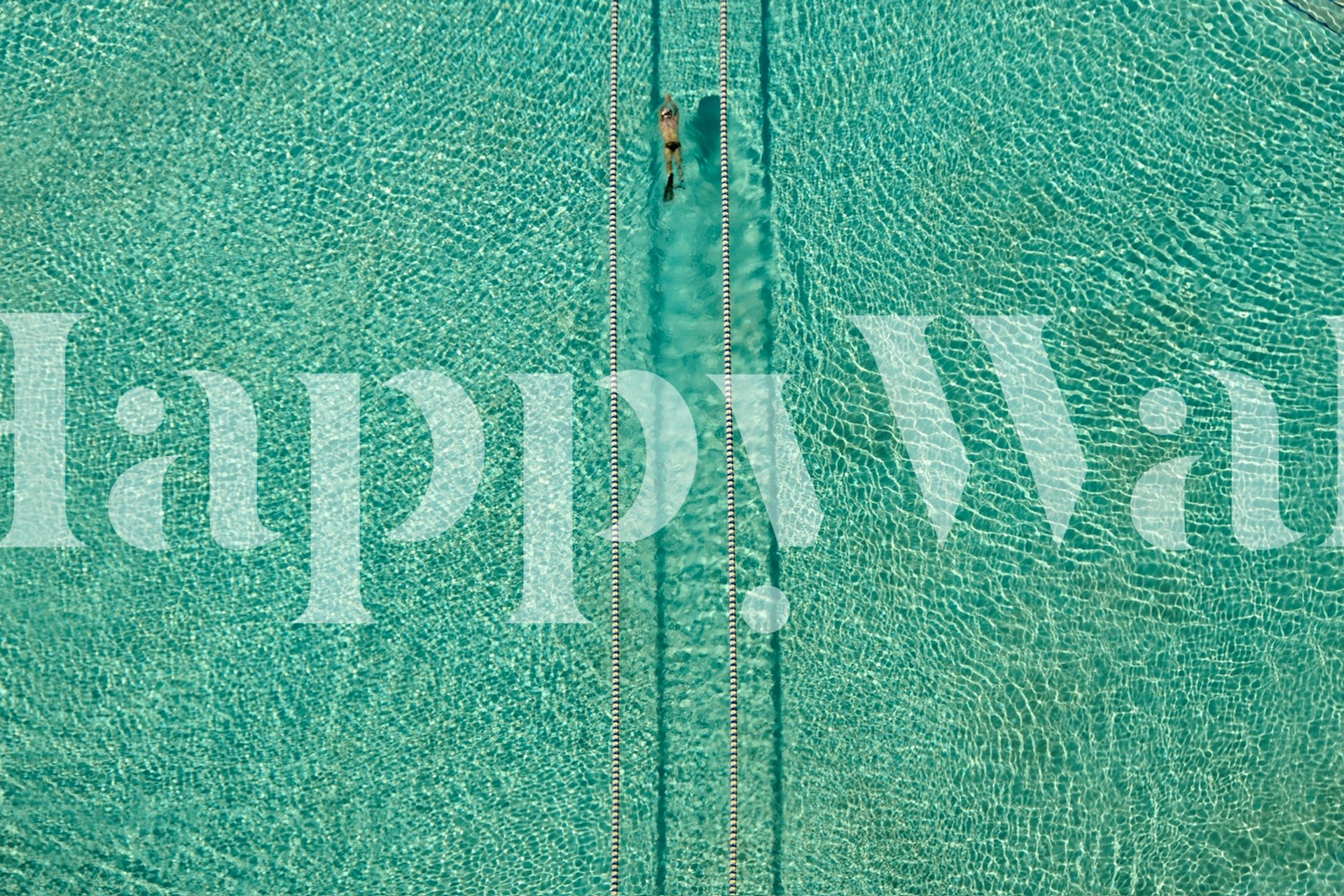 Aerial view of a swimmer in a crystal-clear sea for a wall mural