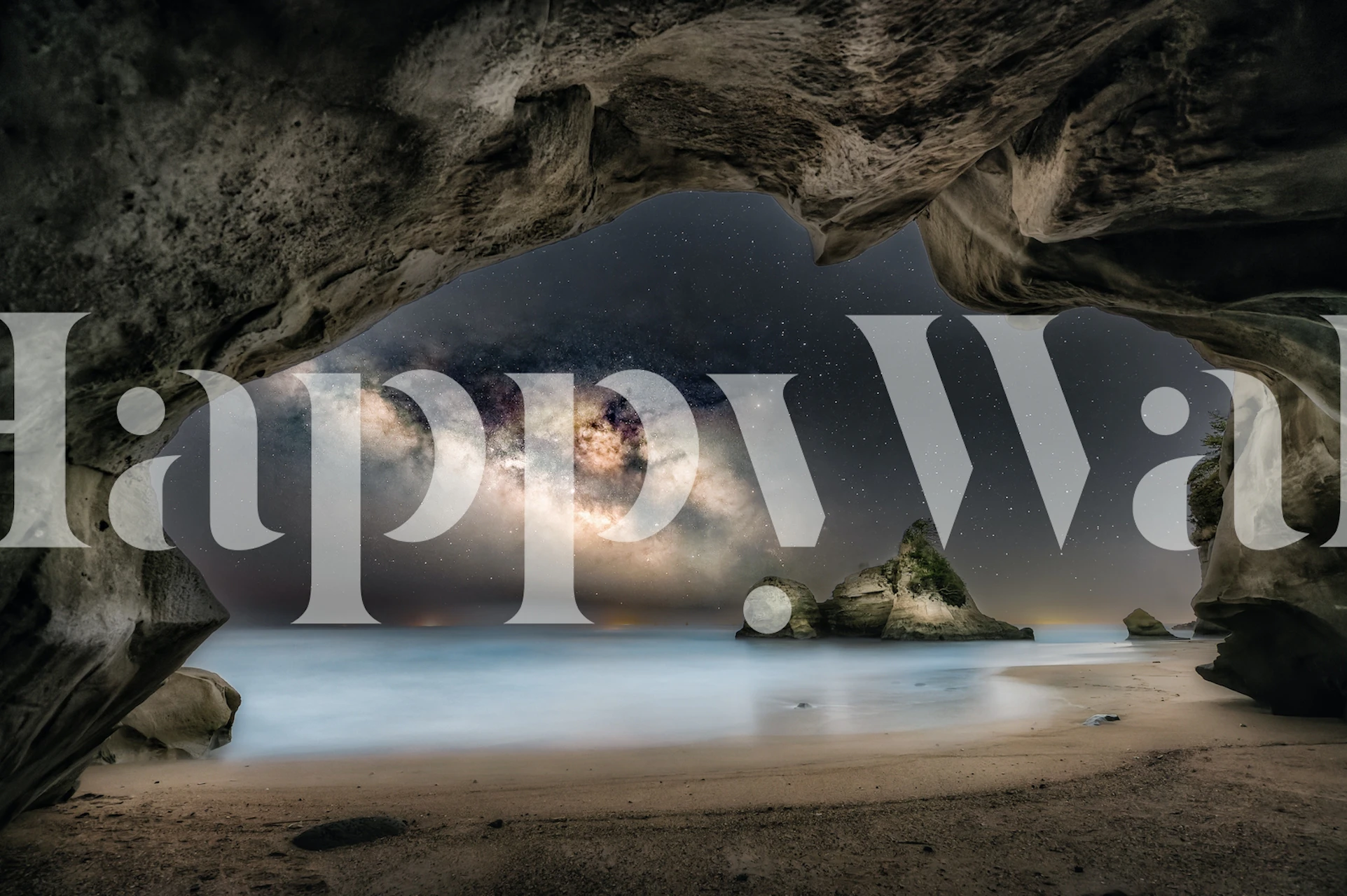 Rocky cave with starry night sky and ocean wallpaper